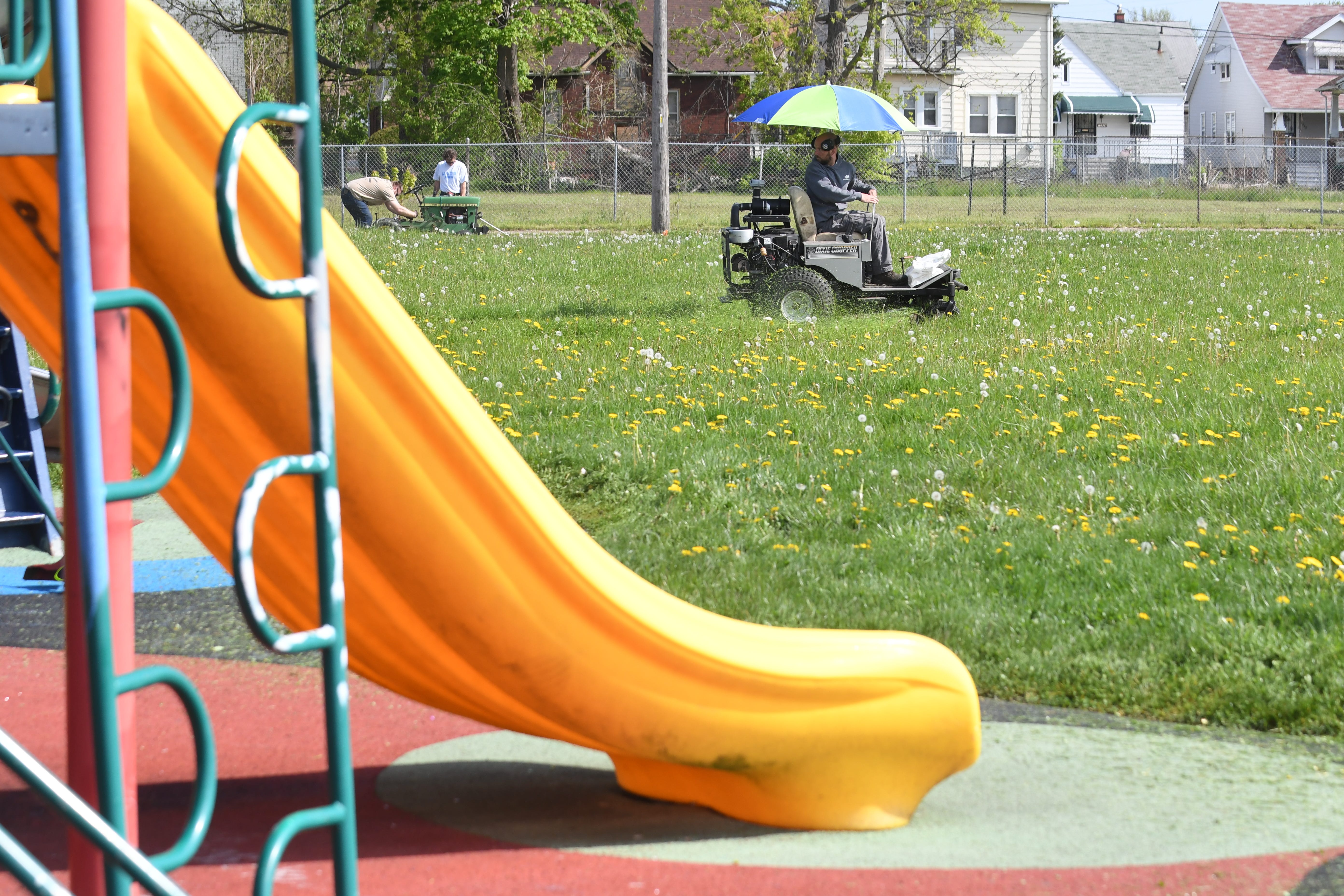 A member of the Detroit Mower Gang starts the 2020 Motown Mowdown near the playscape at Hammerberg Playfield.