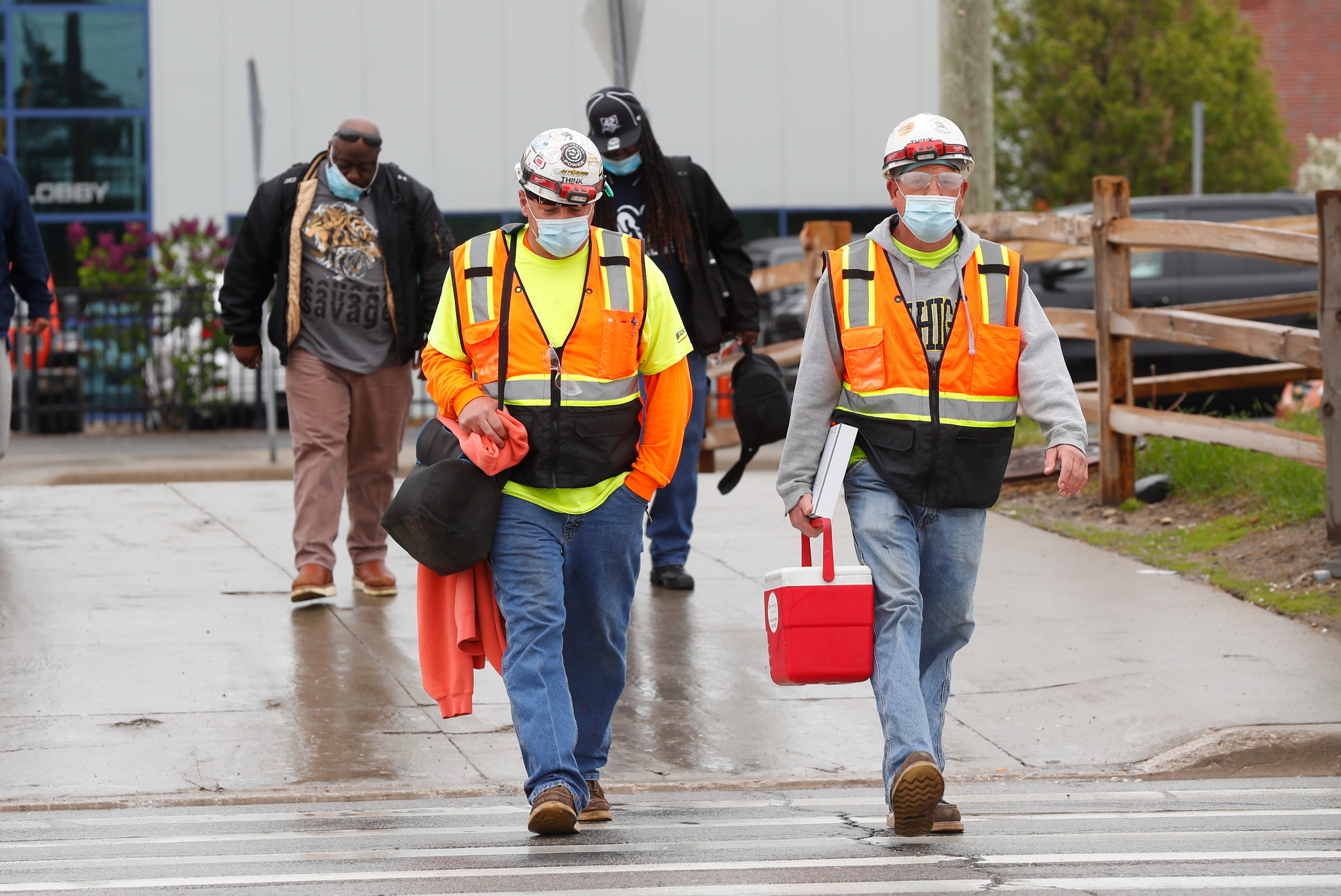 United Auto Workers members leave the Fiat Chrysler Automobiles Warren Truck Plant after the first work shift, Monday, May 18, 2020, in Warren, Mich. Fiat Chrysler Automobiles NV along with rivals Ford and General Motors Co., restarted the assembly lines on Monday after several week of inactivity due to the corona virus pandemic.