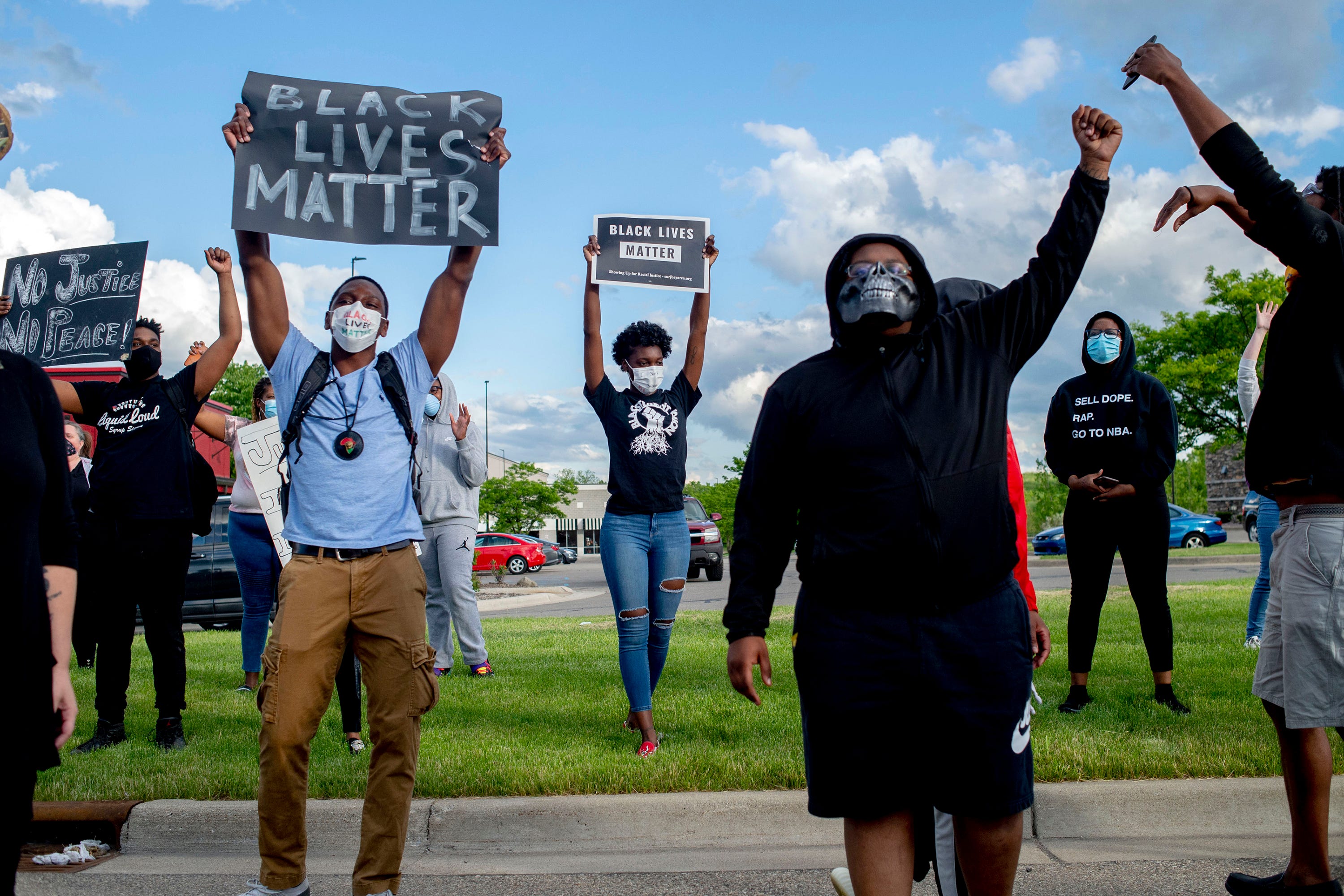 Protesters chant as they march during a peaceful protest seeking justice for George Floyd on Saturday, May 30, 2020 on Miller Road in Flint Township, M.I.  Floyd died in police custody on Memorial Day in Minneapolis. (Jake May/The Flint Journal via AP)