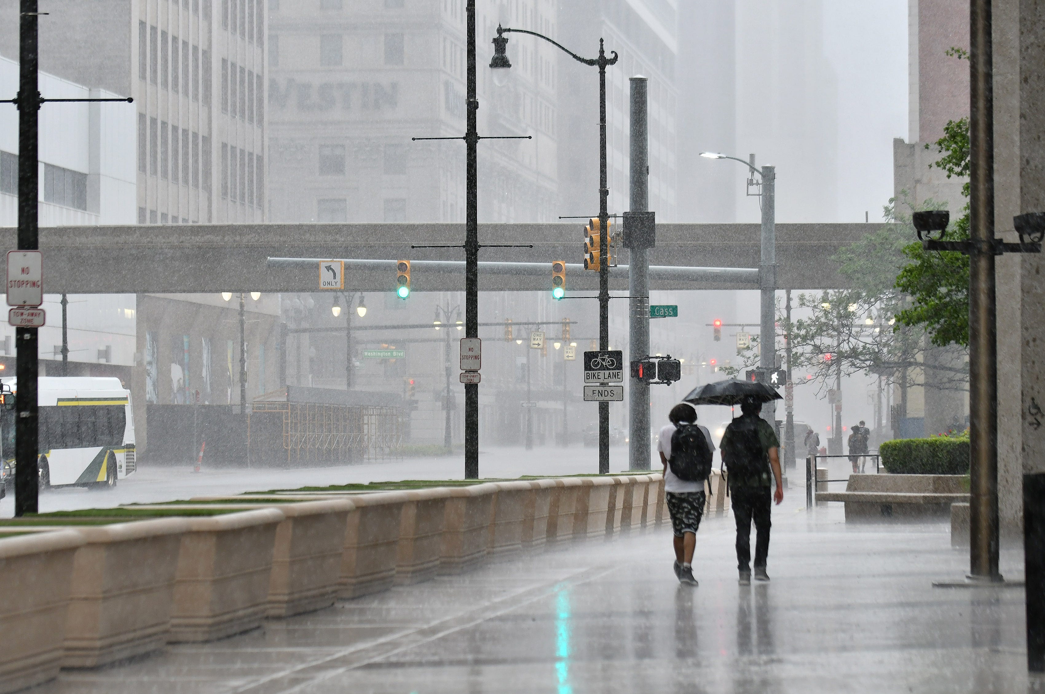 Protesters walk in the rain sheltered by an umbrella down Michigan Avenue after the march against police brutality in Detroit on June 10, 2020. This is the 13th day of protesting in Detroit.