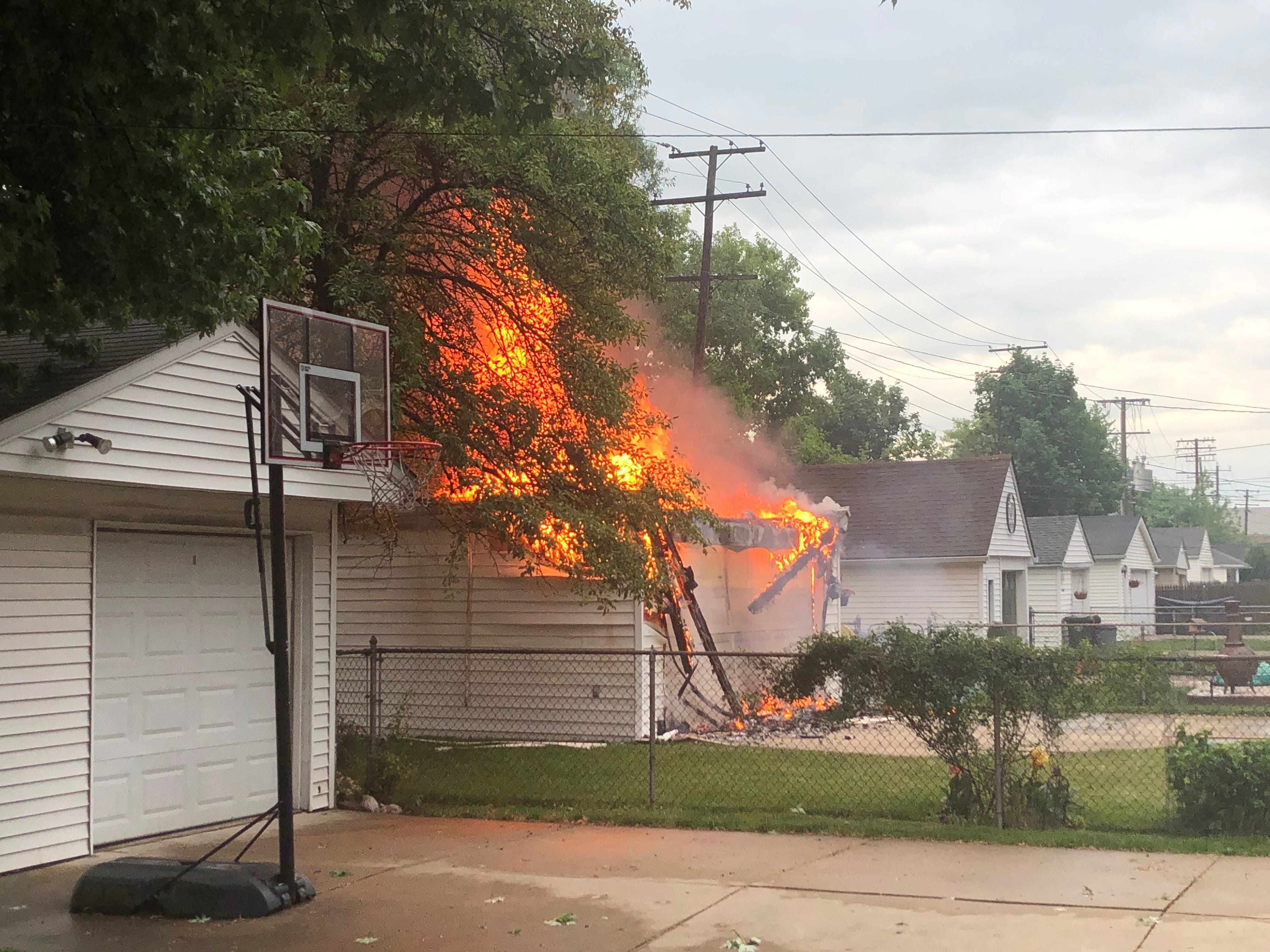 The garage of this Grosse Pointe Woods home allegedly caught fire after downed power lines fell onto it and the surrounding trees.