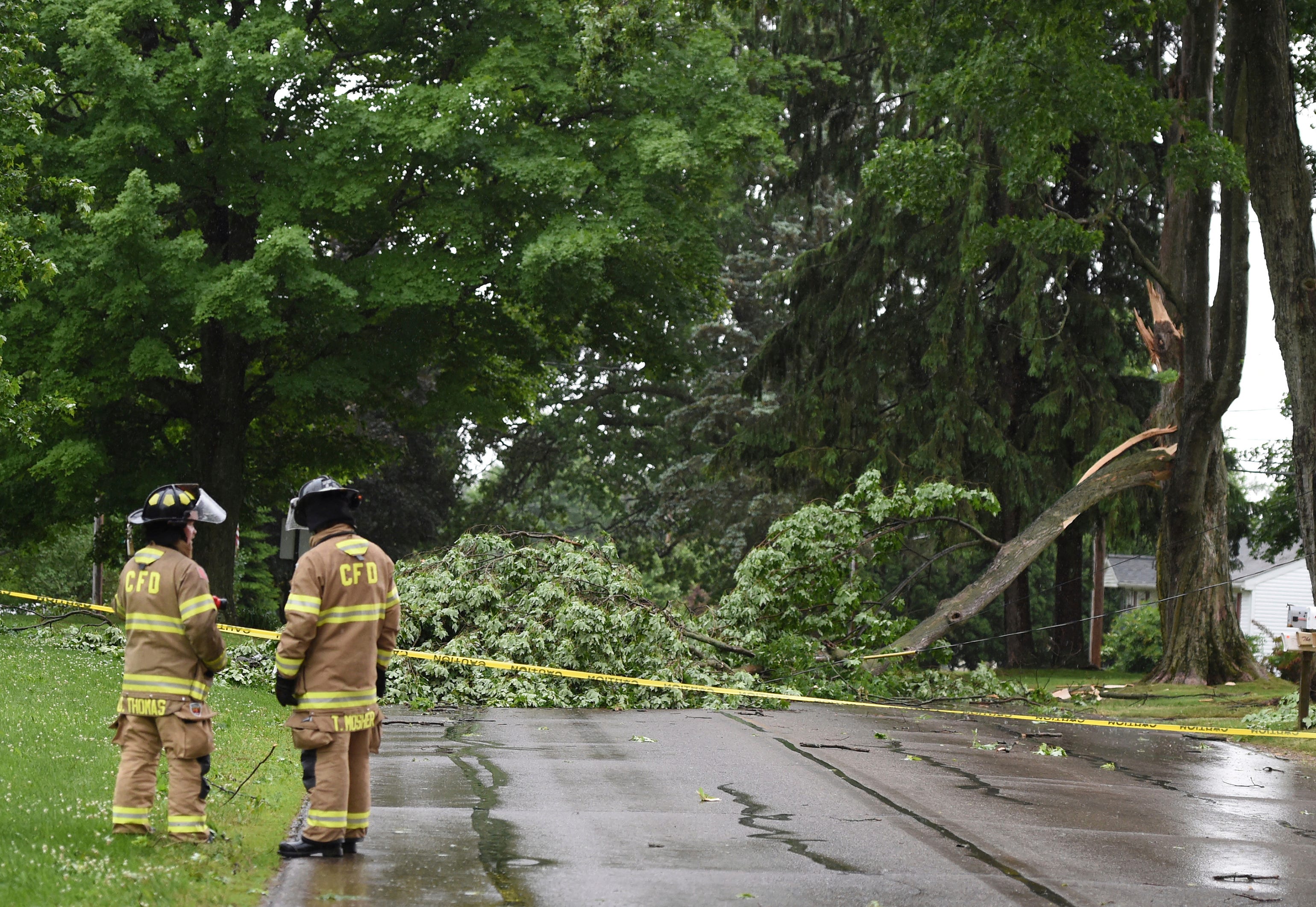Concord firefighters work at the scene of a downed tree and power line on Main Street on Wednesday, June 10, 2020. Strong storms with heavy winds swept across Jackson County causing power outages, downing trees and damaging property.