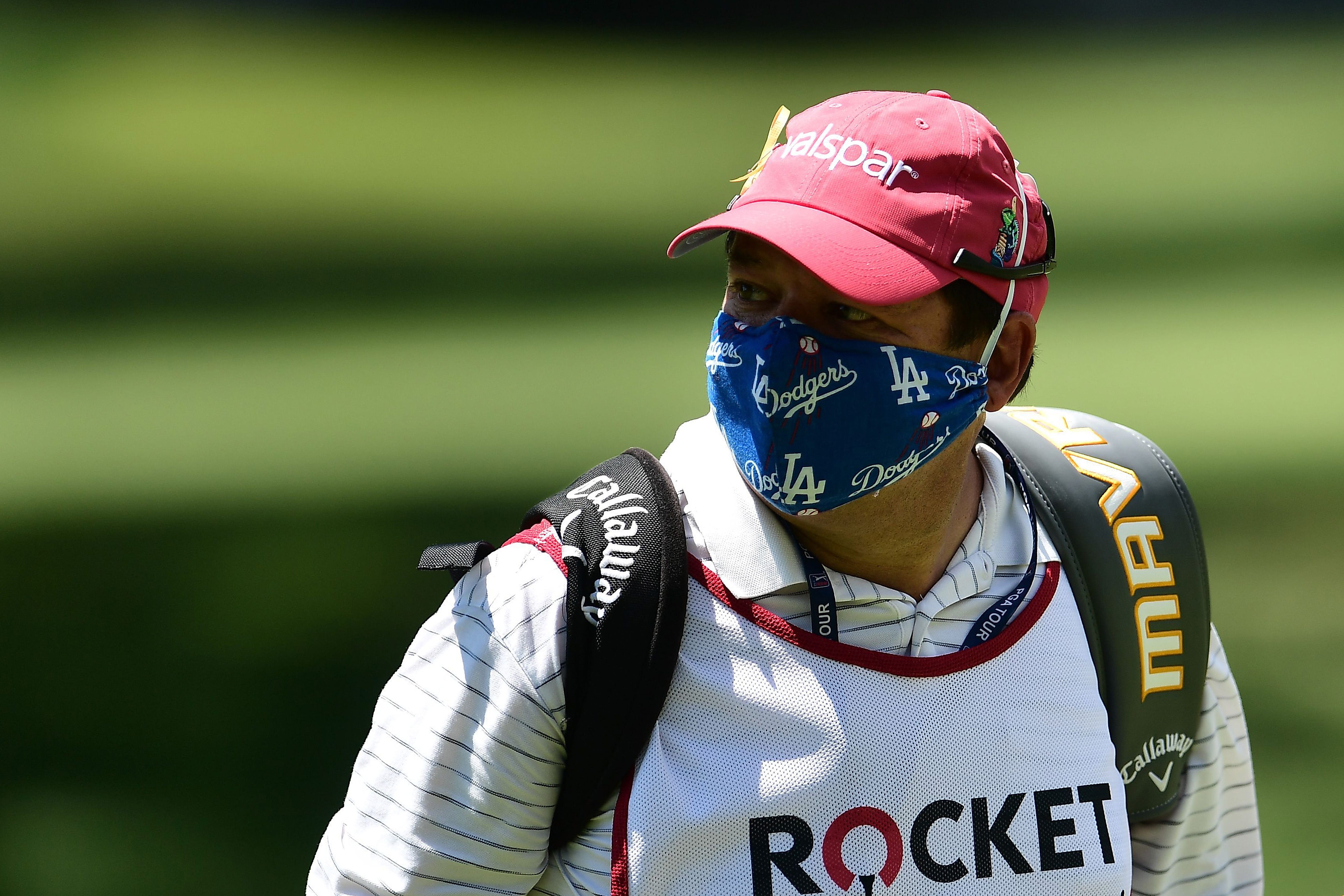 Todd Montoya, caddie for Brian Stuard, wears a mask during the third round of the Rocket Mortgage Classic in 2020.