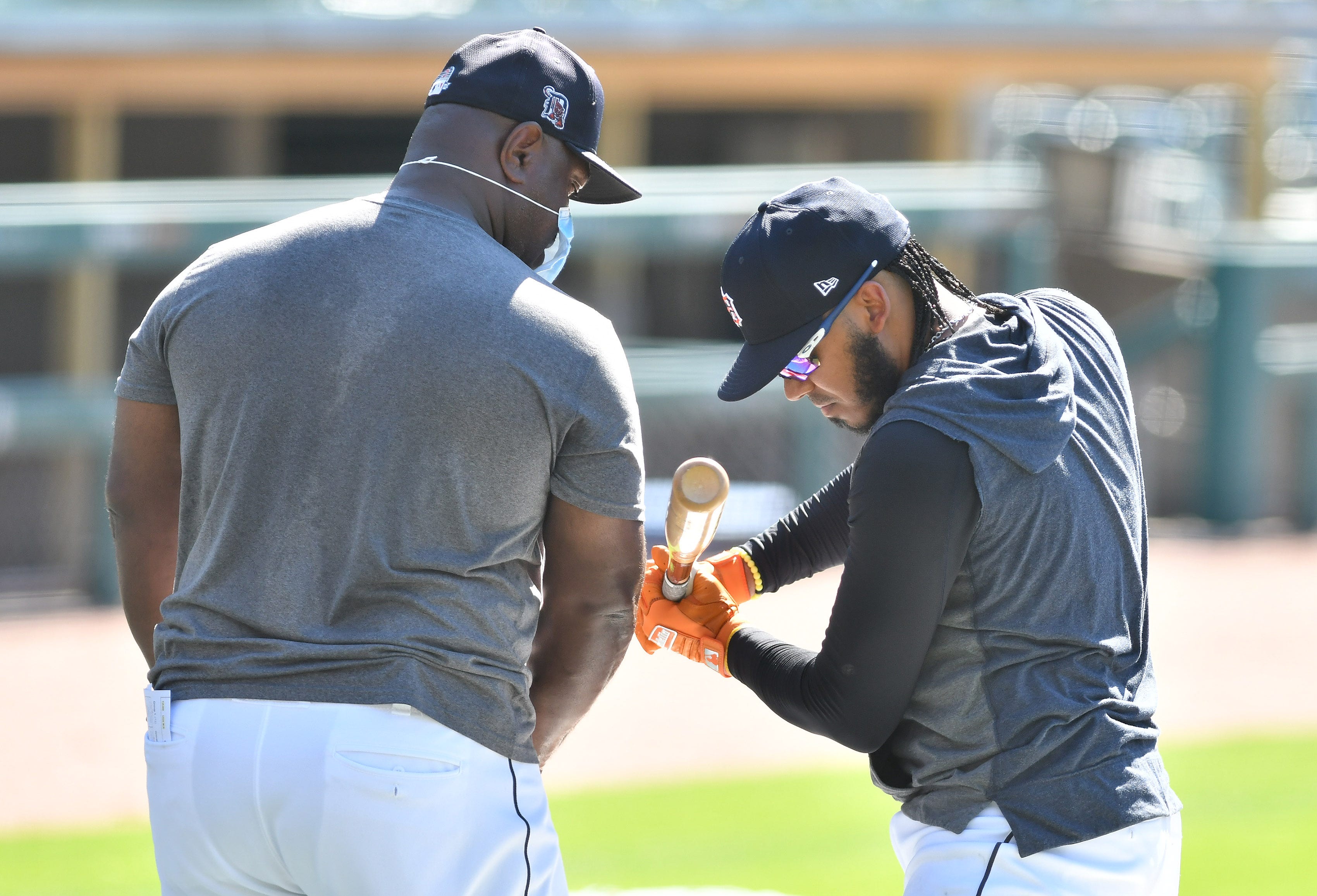 Tigers assistant hitting coach Phil Clark works with Harold Castro during batting practice.