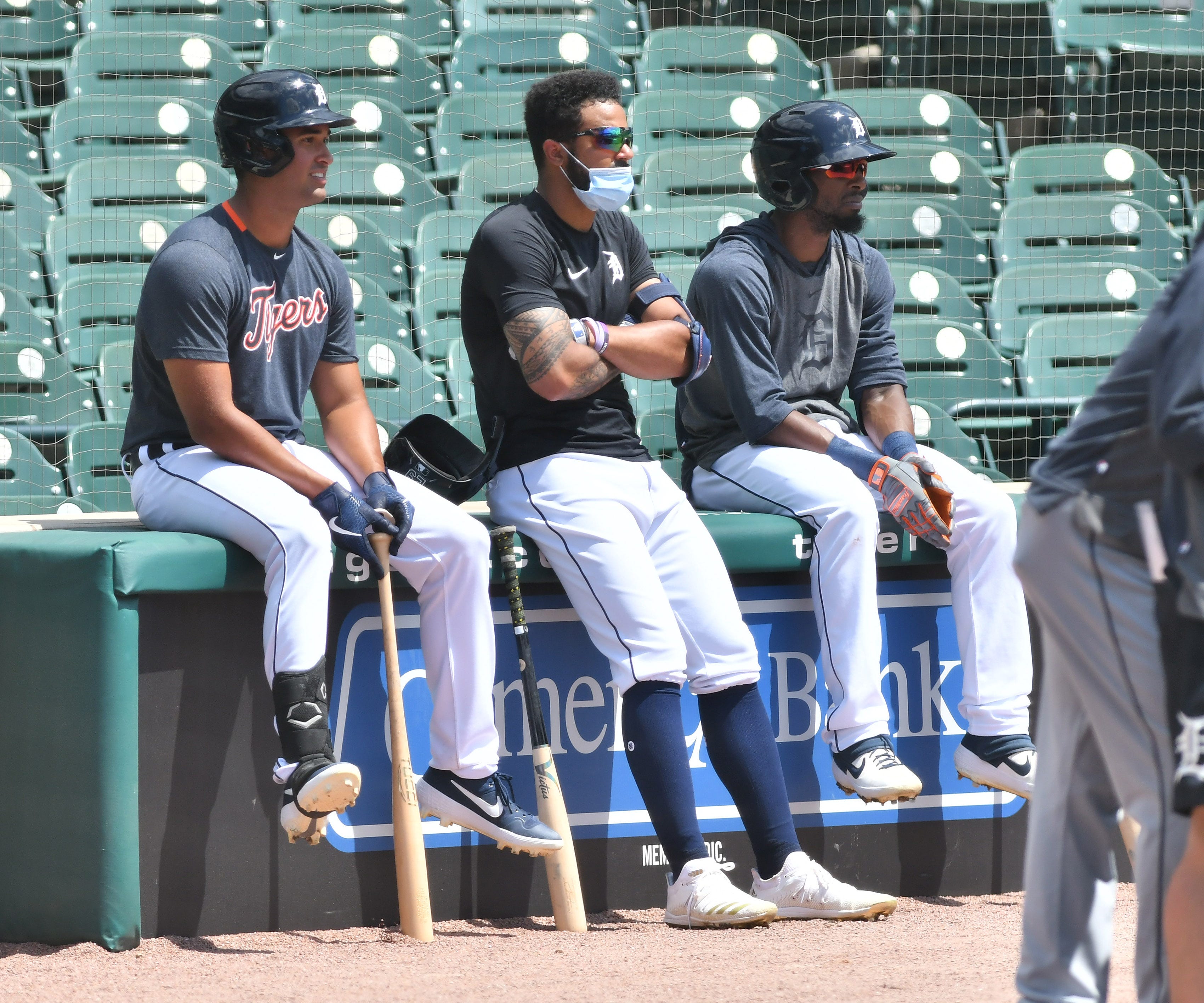 From left, non-roster invitee Riley Greene sits next to Tigers outfielders Derek Hill and Travis Demeritte during batting practice.