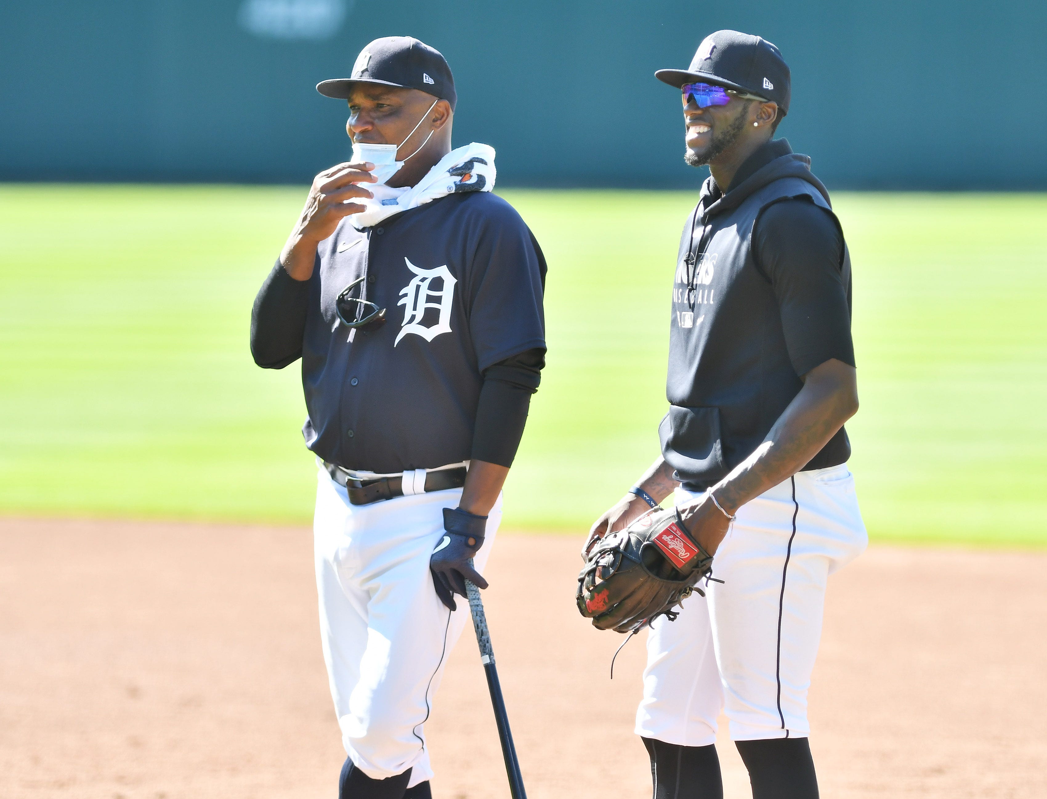 Tigers outfielder Cameron Maybin, right, talks with first base coach Dave Clark.
