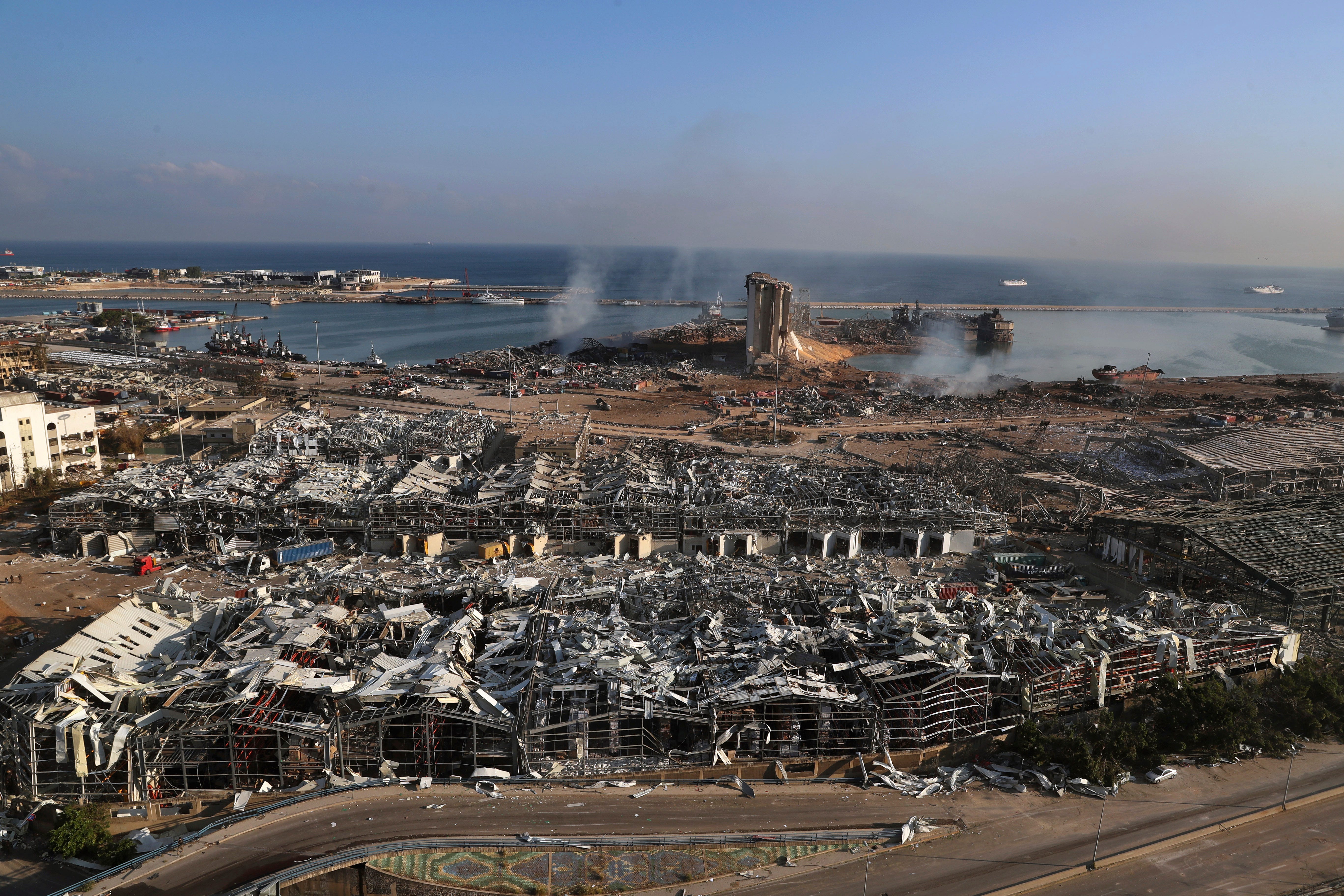 This photo shows a general view of the scene of an explosion that hit the seaport of Beirut, Lebanon, Wednesday, Aug. 5, 2020. A massive explosion rocked Beirut on Tuesday, flattening much of the city's port, damaging buildings across the capital and sending a giant mushroom cloud into the sky.