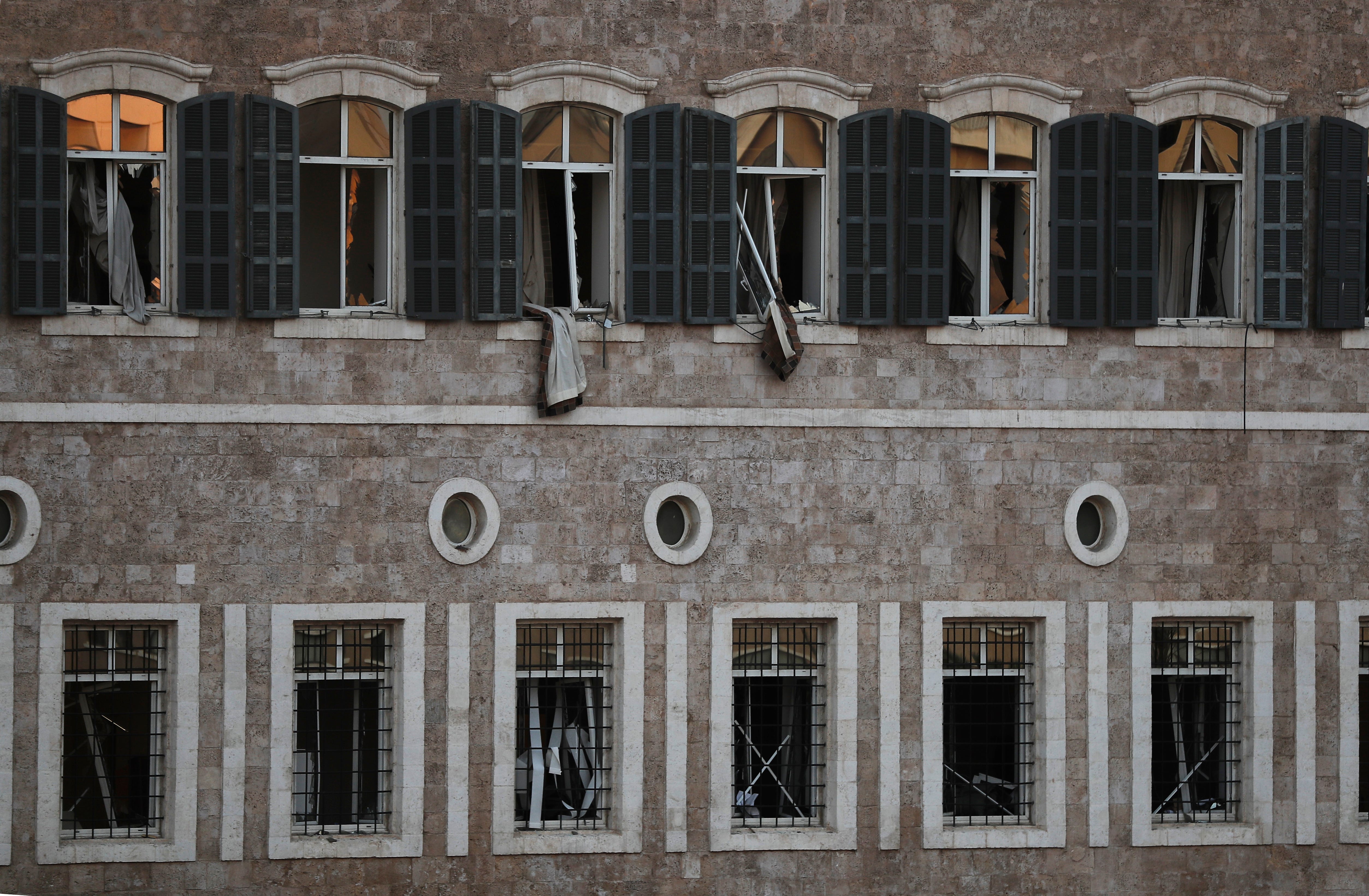 Windows of the Lebanese Government Palace are seen damaged after an explosion hit the seaport of Beirut, Lebanon, Tuesday, Aug. 4, 2020. Massive explosions rocked downtown Beirut on Tuesday, flattening much of the port, damaging buildings and blowing out windows and doors as a giant mushroom cloud rose above the capital.