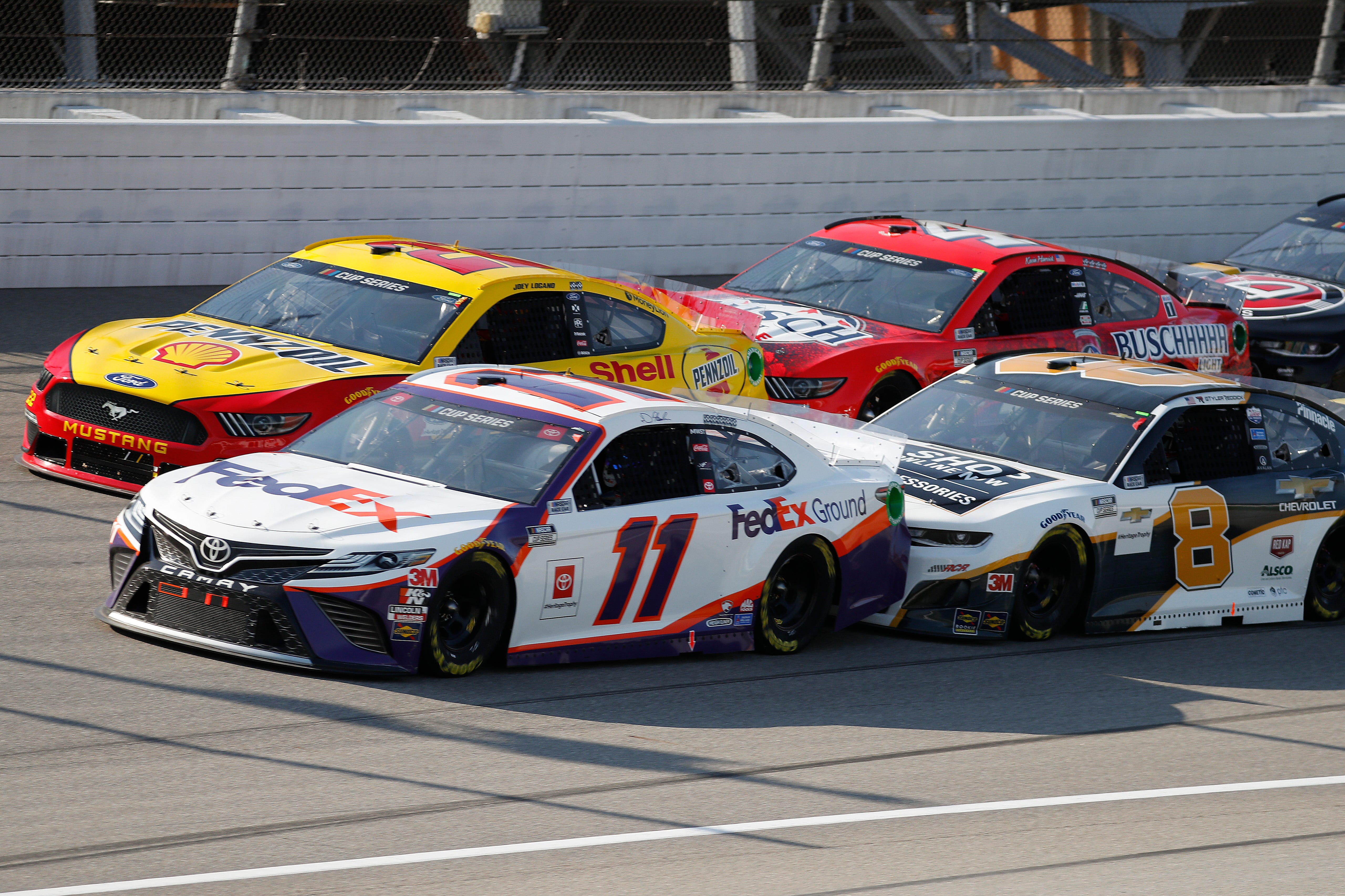 Denny Hamlin (11), Joey Logano (22), Kevin Harvick (4) and Tyler Reddick (8) compete during a NASCAR Cup Series auto race at Michigan International Speedway.