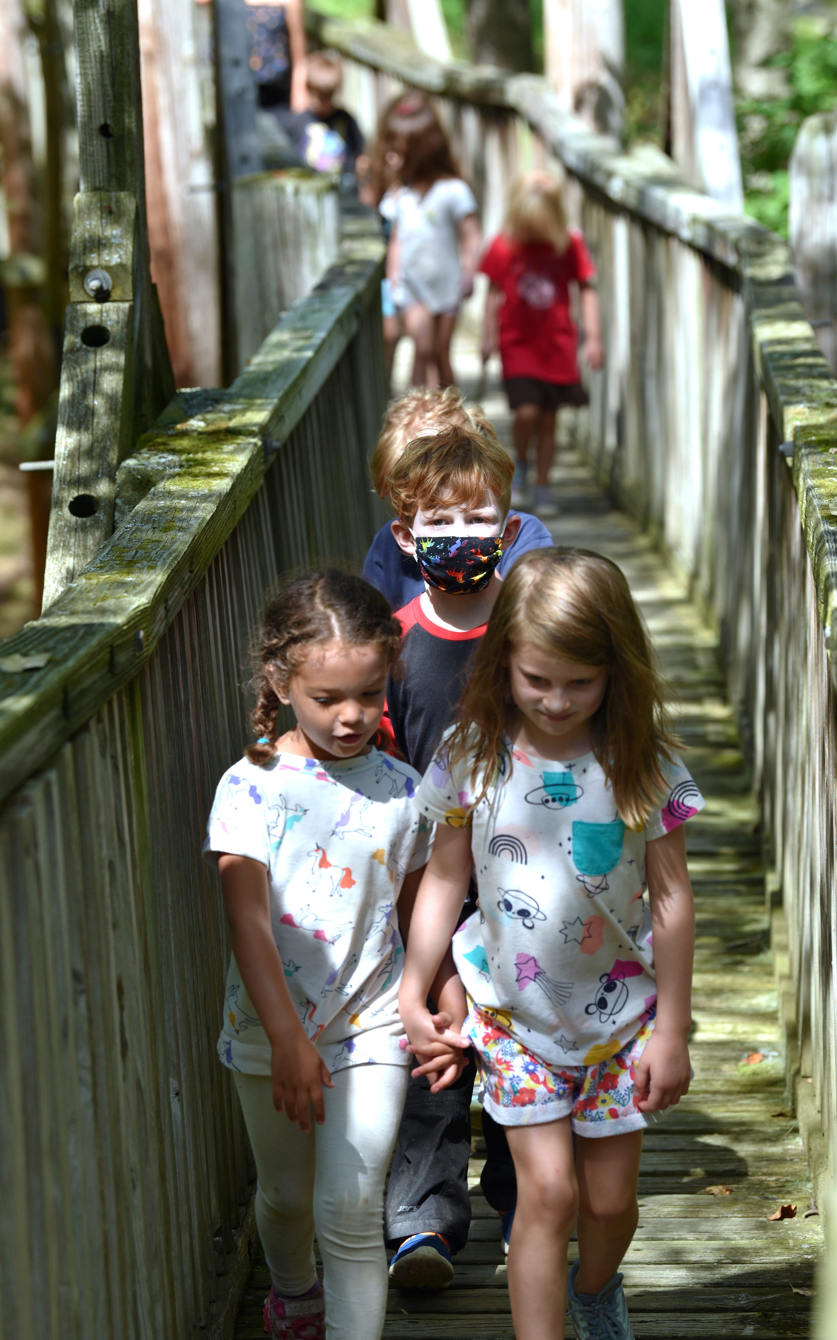 Six-year-old students cross The Bridge en route to Prince Lake for the afternoon. The Bridge was built almost 20 years ago by students at the school.