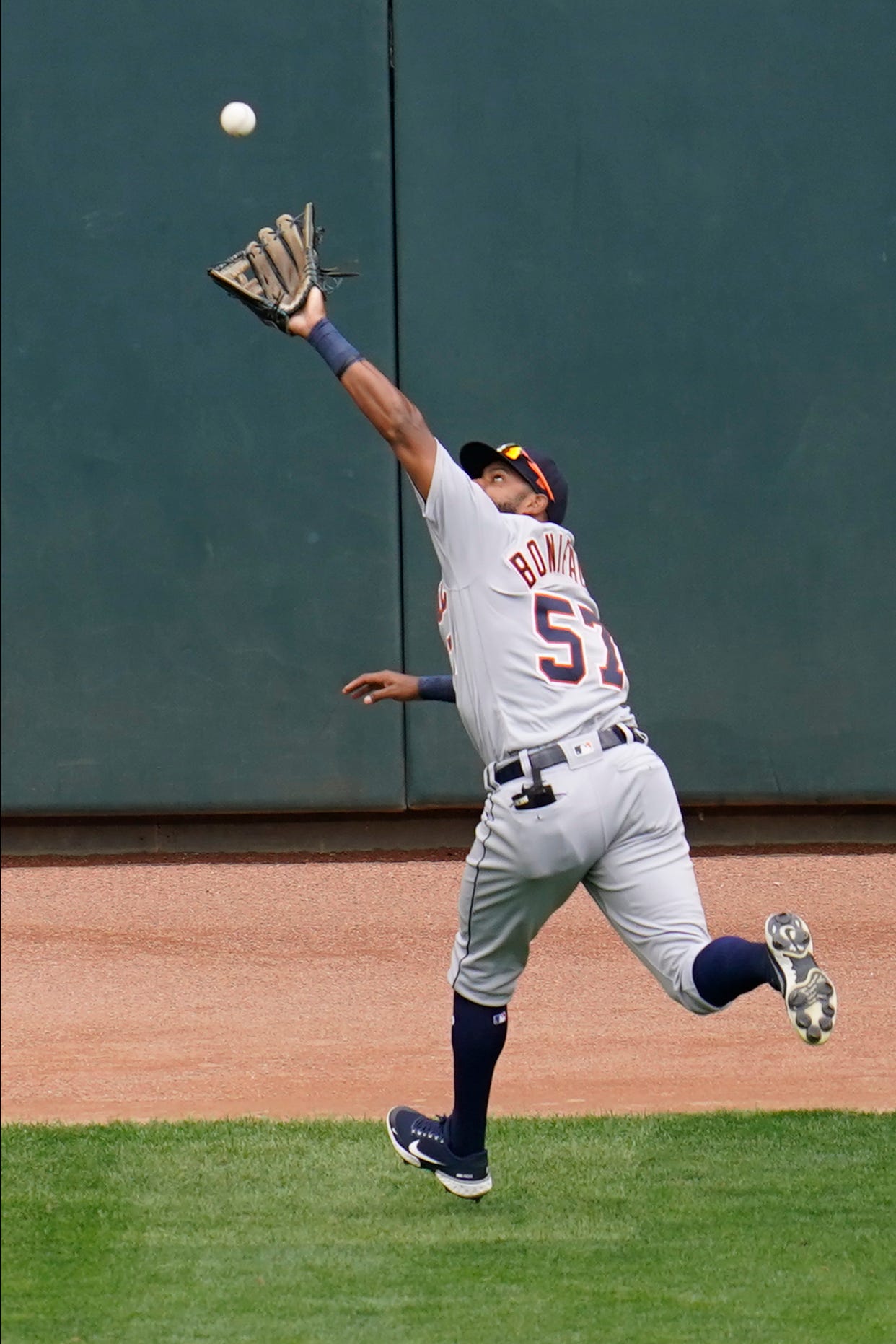Detroit Tigers left fielder Jorge Bonafacio reaches and catches a fly ball off the bat of Minnesota Twins ' Luis Arraez in the first inning.
