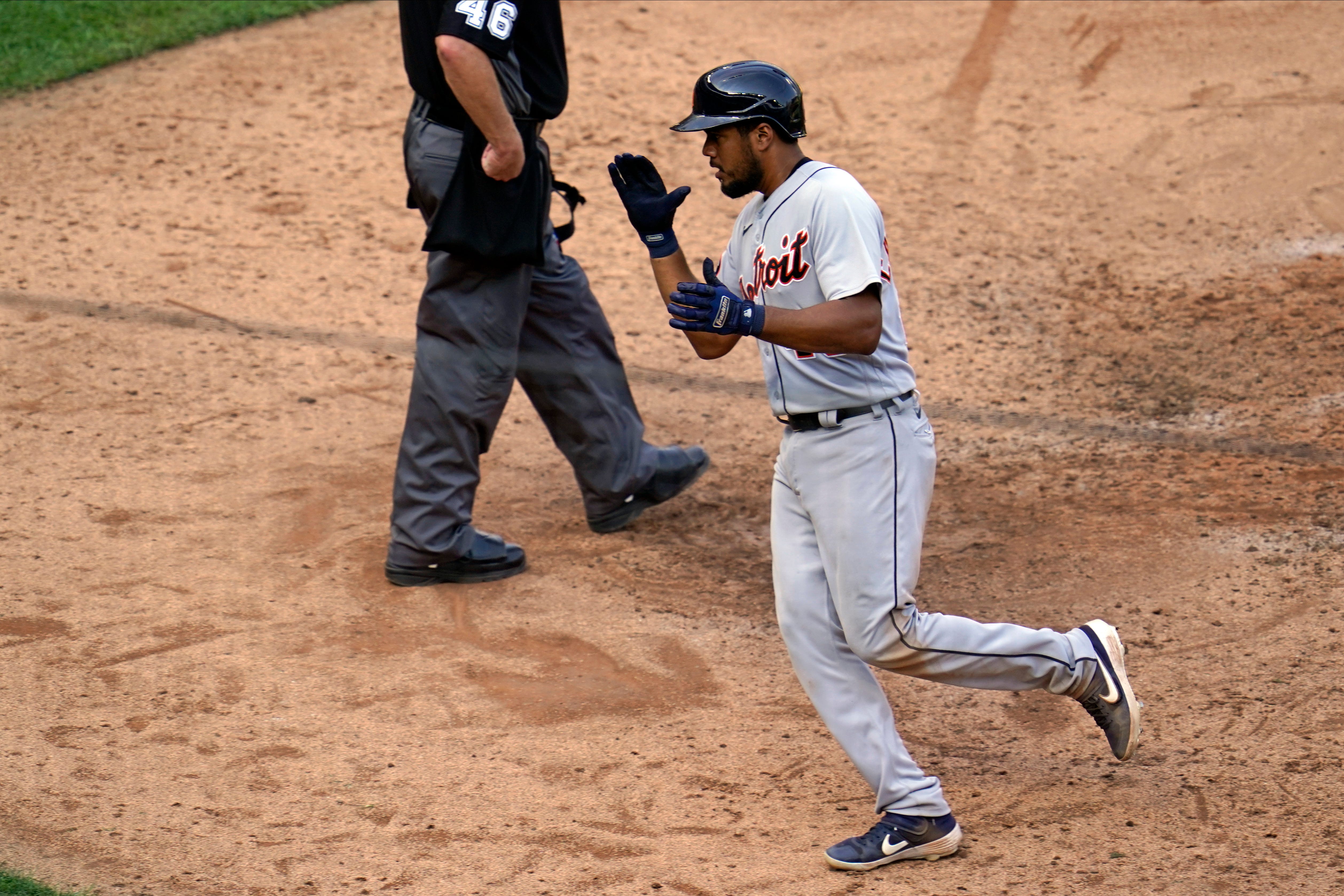 Detroit Tigers' Jeimer Candelario applauds as he scores to tie a baseball game on a single by Willi Castro off Minnesota Twins' pitcher Tyler Duffey in the seventh inning.