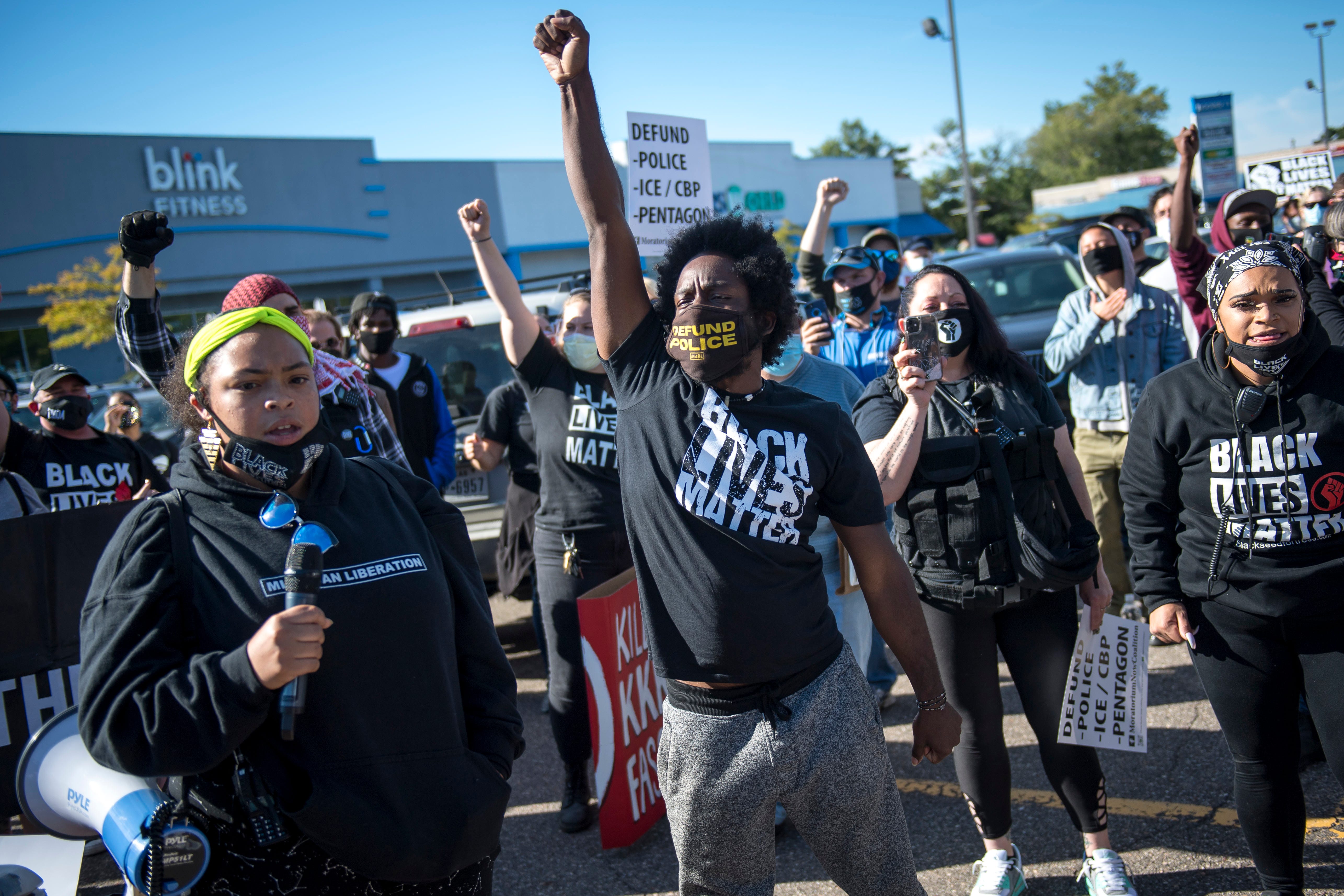 Tristan Taylor raises his fist before the March Against Racism in Warren on Sept. 19, 2020. The march in Warren occurred in response to the city called hate crimes against residents Candace Hall, her husband Eddie and their two children.