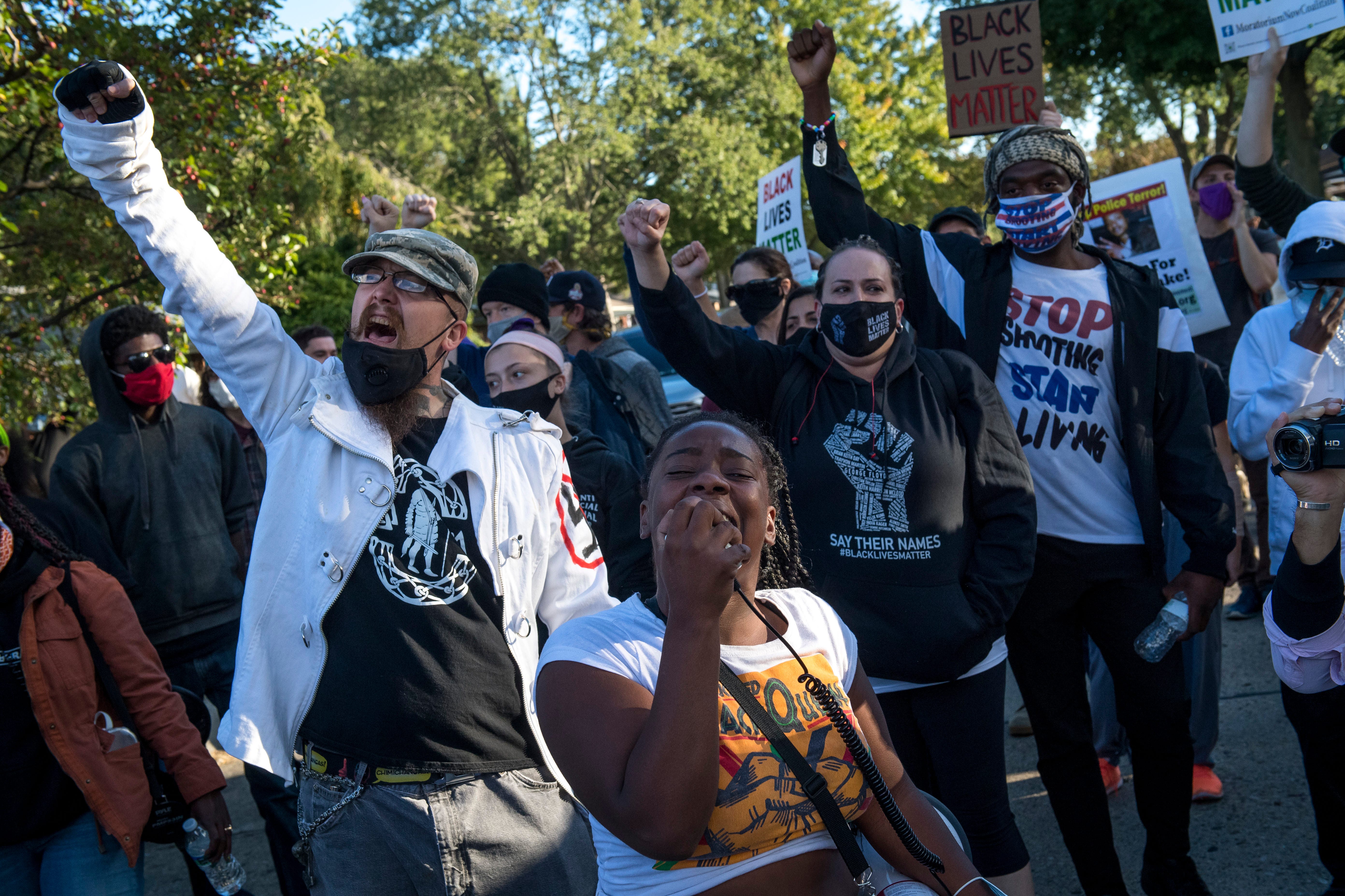 Shaqualla Johnson of Detroit chants during the March Against Racism in Warren on Sept. 19, 2020. The march in Warren occurred in response to what the city called hate crimes that terrorized residents Candace Hall, her husband Eddie and their two children.