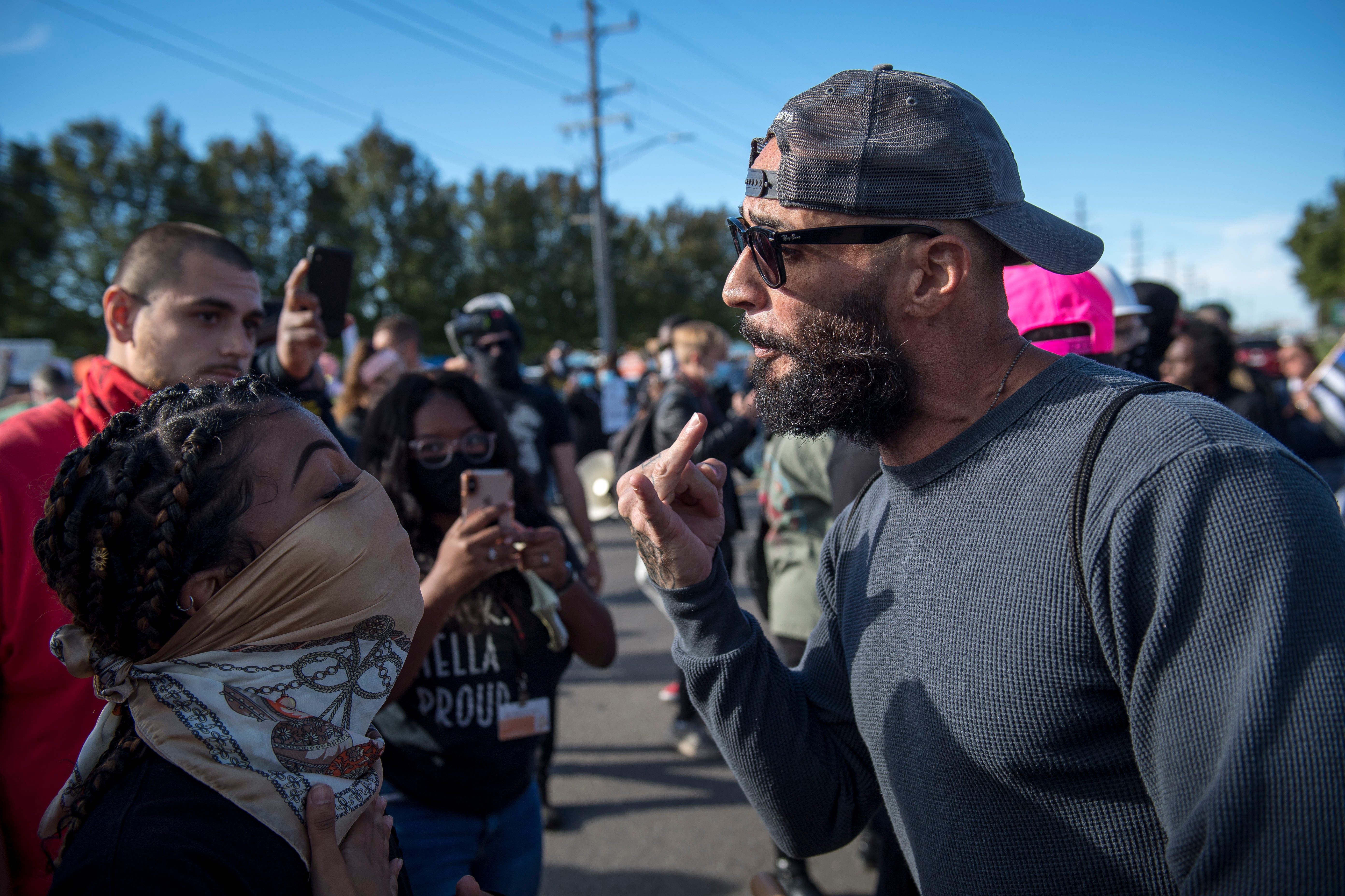 A Detroit Will Breathe protester argues with a Trump supporter before the March Against Racism in Warren on Sept. 19, 2020. The march in Warren occurred in response to the city called hate crimes against residents Candace Hall, her husband Eddie and their two children.