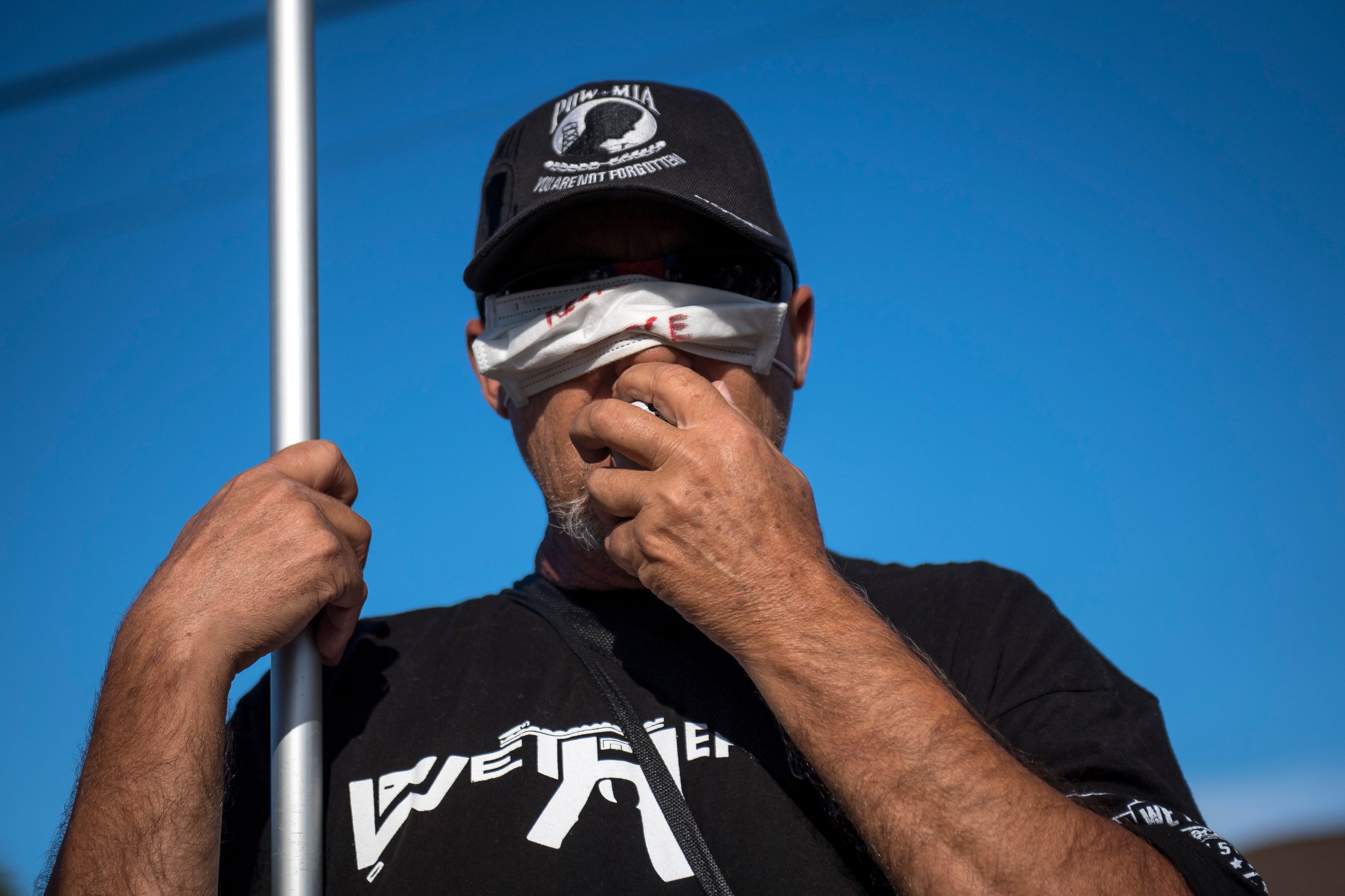 A Trump supporter improperly wears a mask while counter protestering the March Against Racism in Warren on Sept. 19, 2020. The march in Warren occurred in response to the city called hate crimes against residents Candace Hall, her husband Eddie and their two children.
