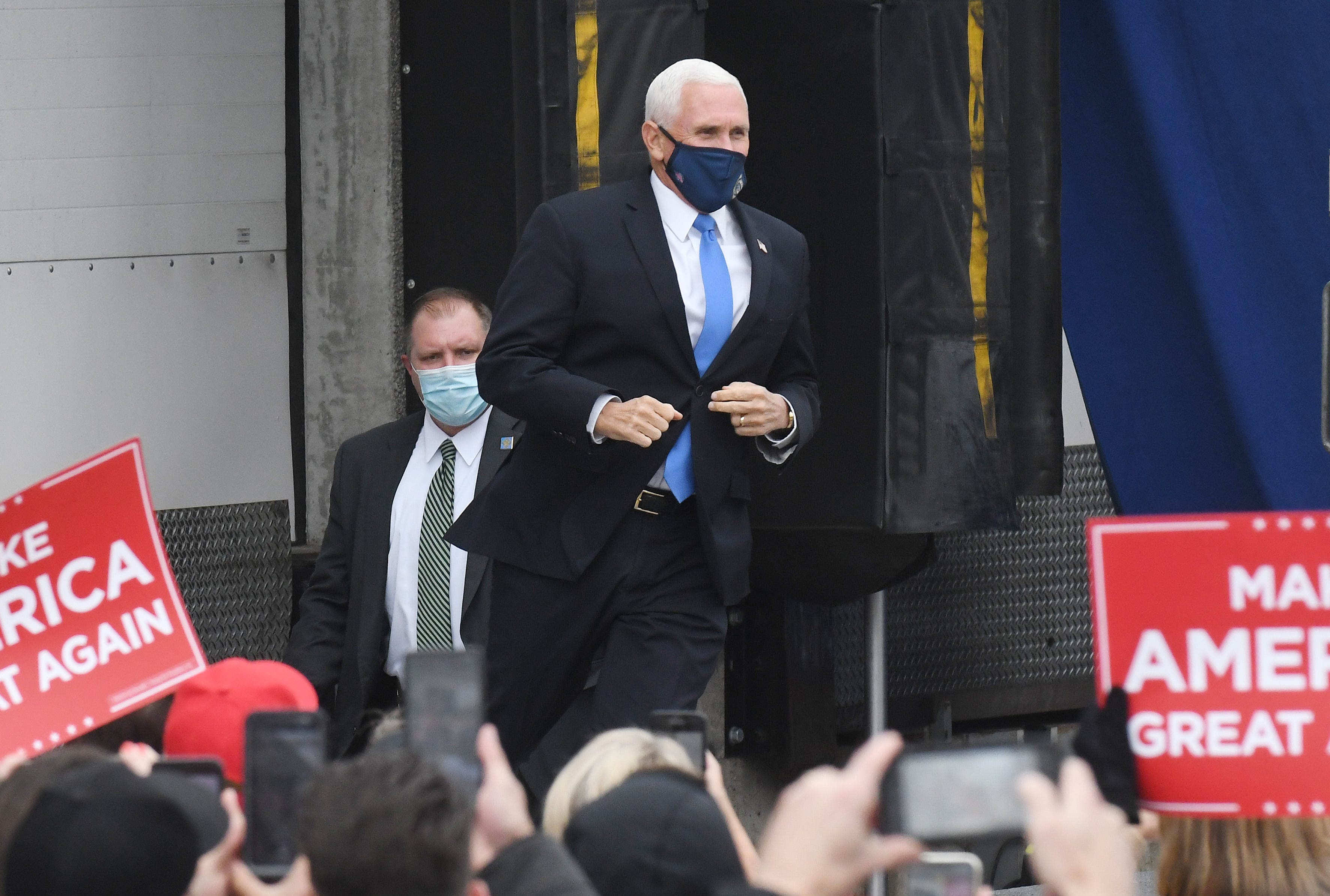 Vice President Mike Pence jogs up to the stage during a campaign stop to Lacks Enterprises Inc. in Grand Rapids, Michigan on October 14, 2020.