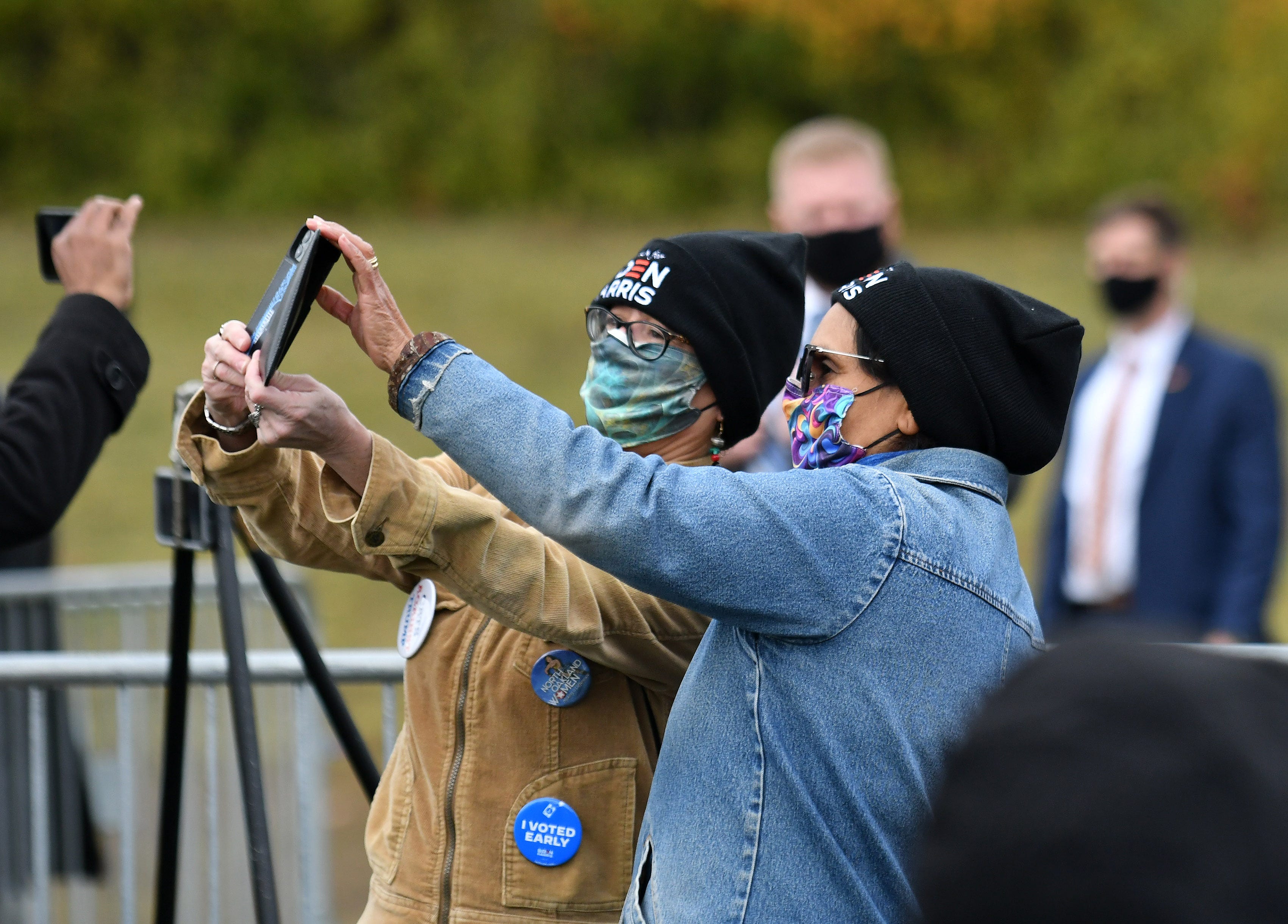 Two Biden Harris supporters take a selfie as Democratic vice presidential candidate Sen. Kamala Harris speaks at the Canvass Kickoff event at the Troy Community Center in Troy, Mich. in Detroit on Oct. 25, 2020.