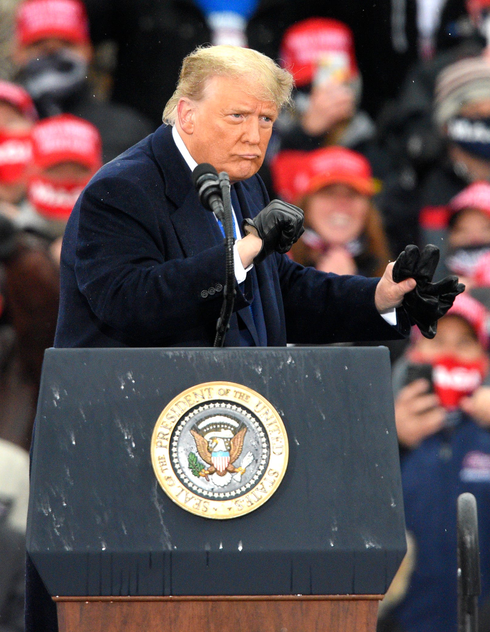 President Donald Trump punches his fists back and forth after his campaign rally speech in Lansing Tuesday, one week before election day. Trump likely needs to win Michigan to win a second term in office.