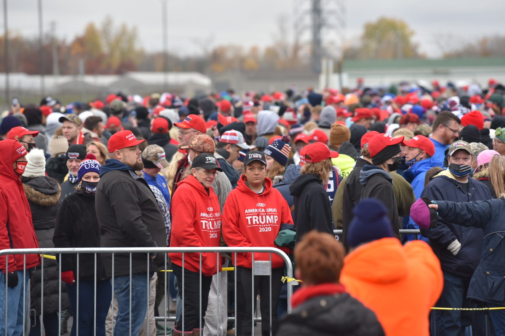 Crowds line up outside the venue before President Donald Trump addresses supporters during his Make America Great Again Victory Rally at AV Flight at the Capital Region International Airport in Lansing, Tuesday, October 27, 2020.