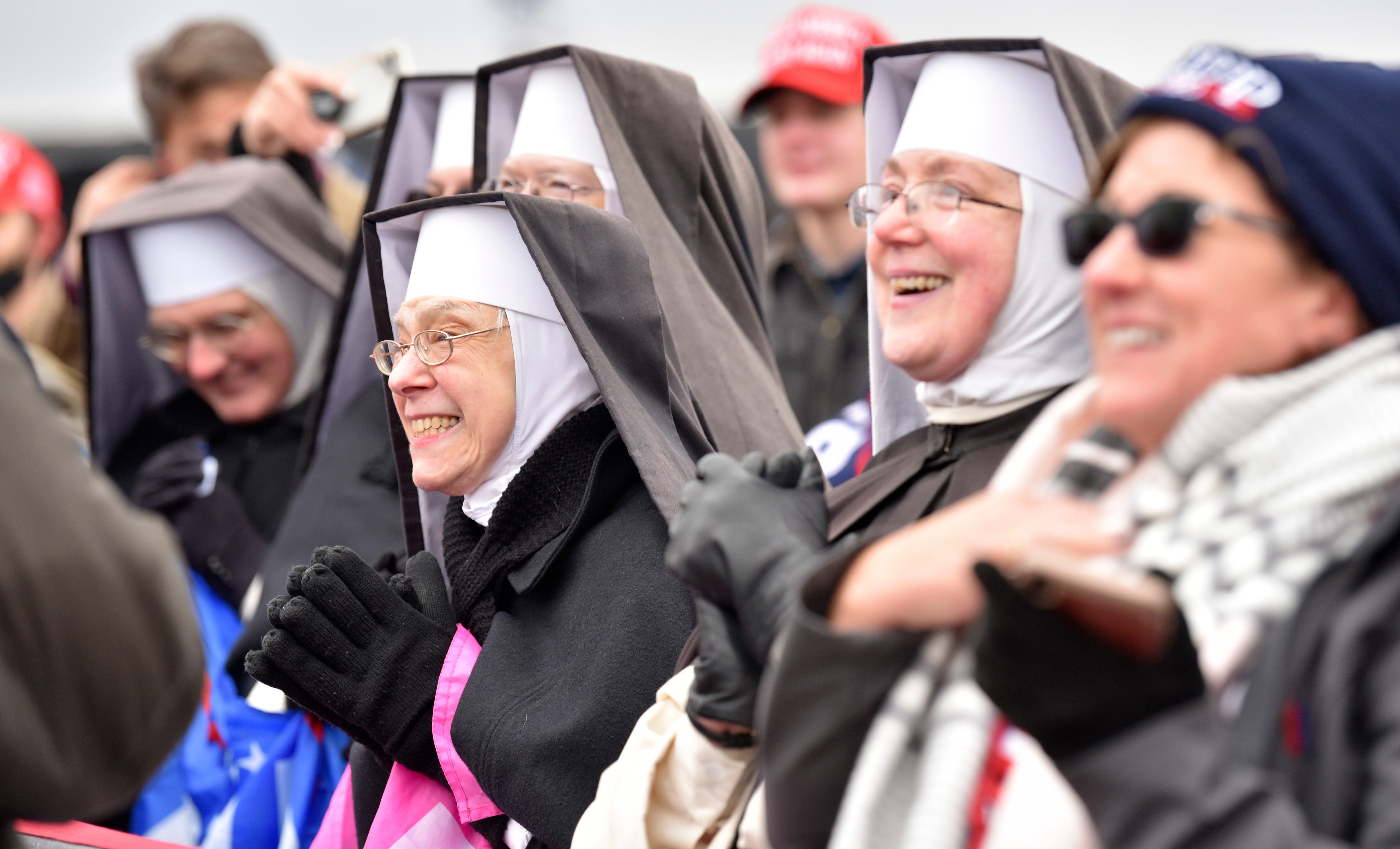 Dominican Sisters from Hartland, MI listen to the president at the Oakland International Airport in Waterford Twp., Friday, October 30, 2020, for his Make America Great Again Victory Rally.