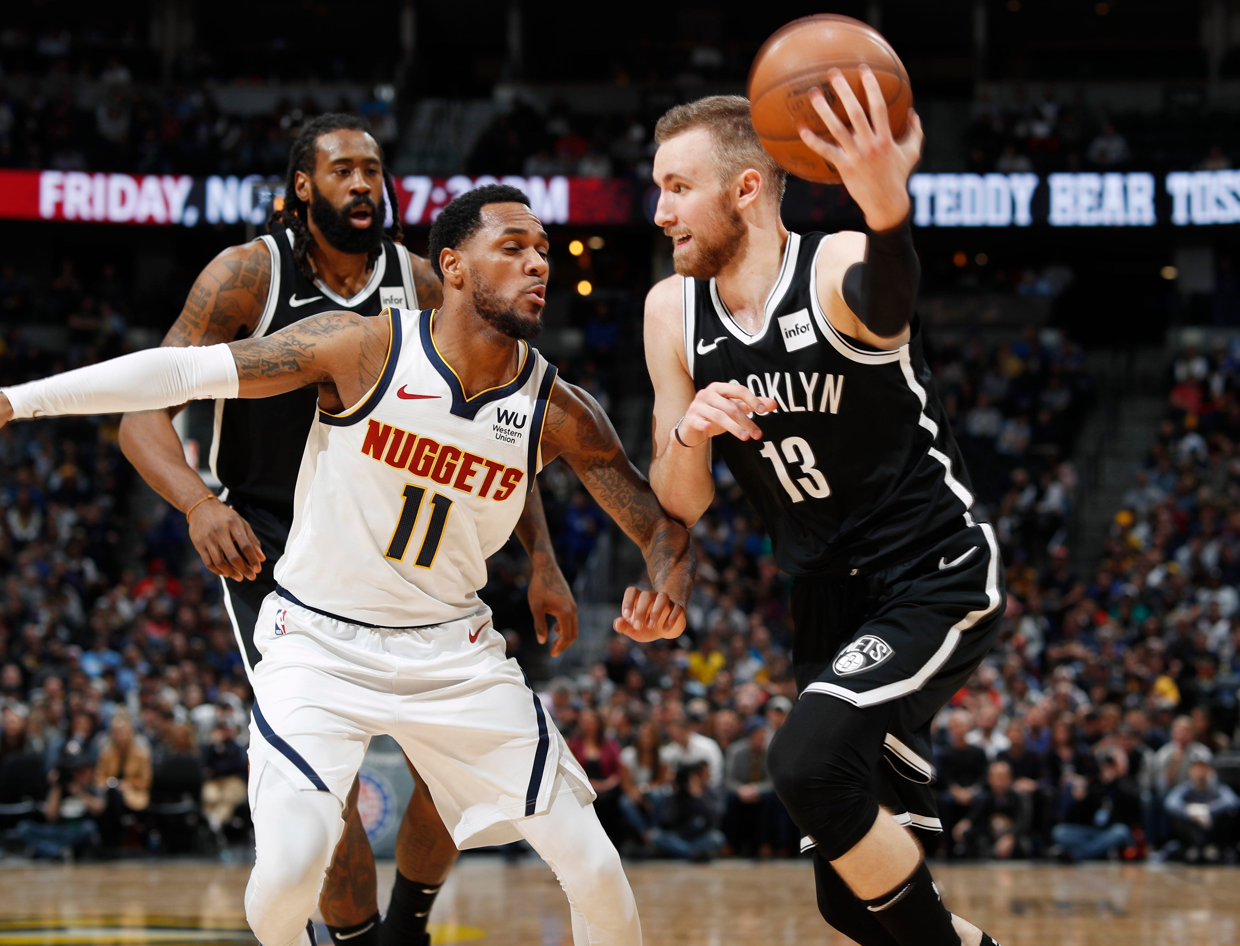 Brooklyn Nets guard Dzanan Musa, right, drives to the rim as Denver Nuggets guard Monte Morris defends in the second half of an NBA basketball game Thursday, Nov. 14, 2019 in Denver. The Nuggets won 101-93.