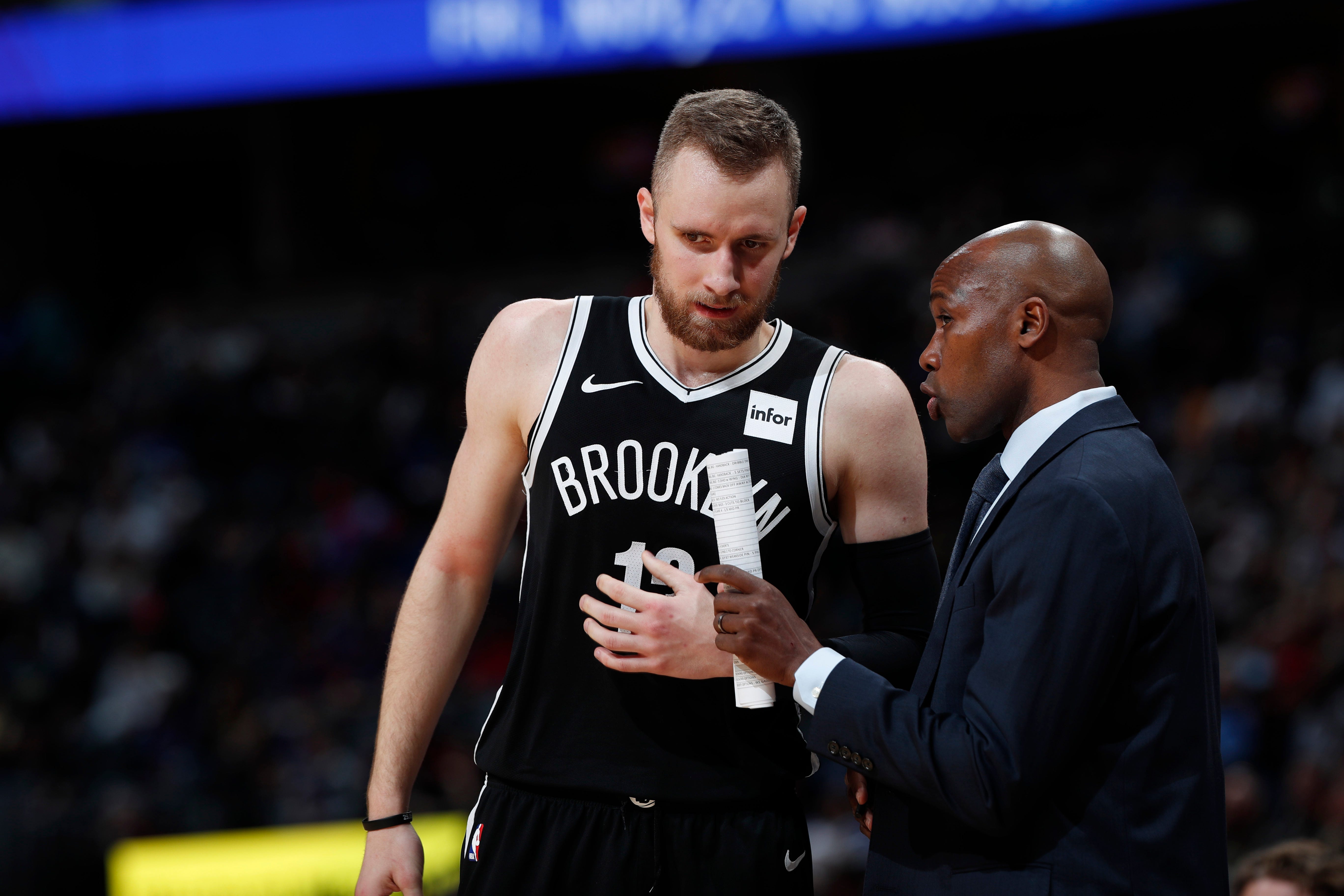 Brooklyn Nets guard Dzanan Musa (13) chats with assistant coach Jacque Vaughn in the second half of an NBA basketball game Thursday, Nov. 14, 2019 in Denver. The Nuggets won 101-93.