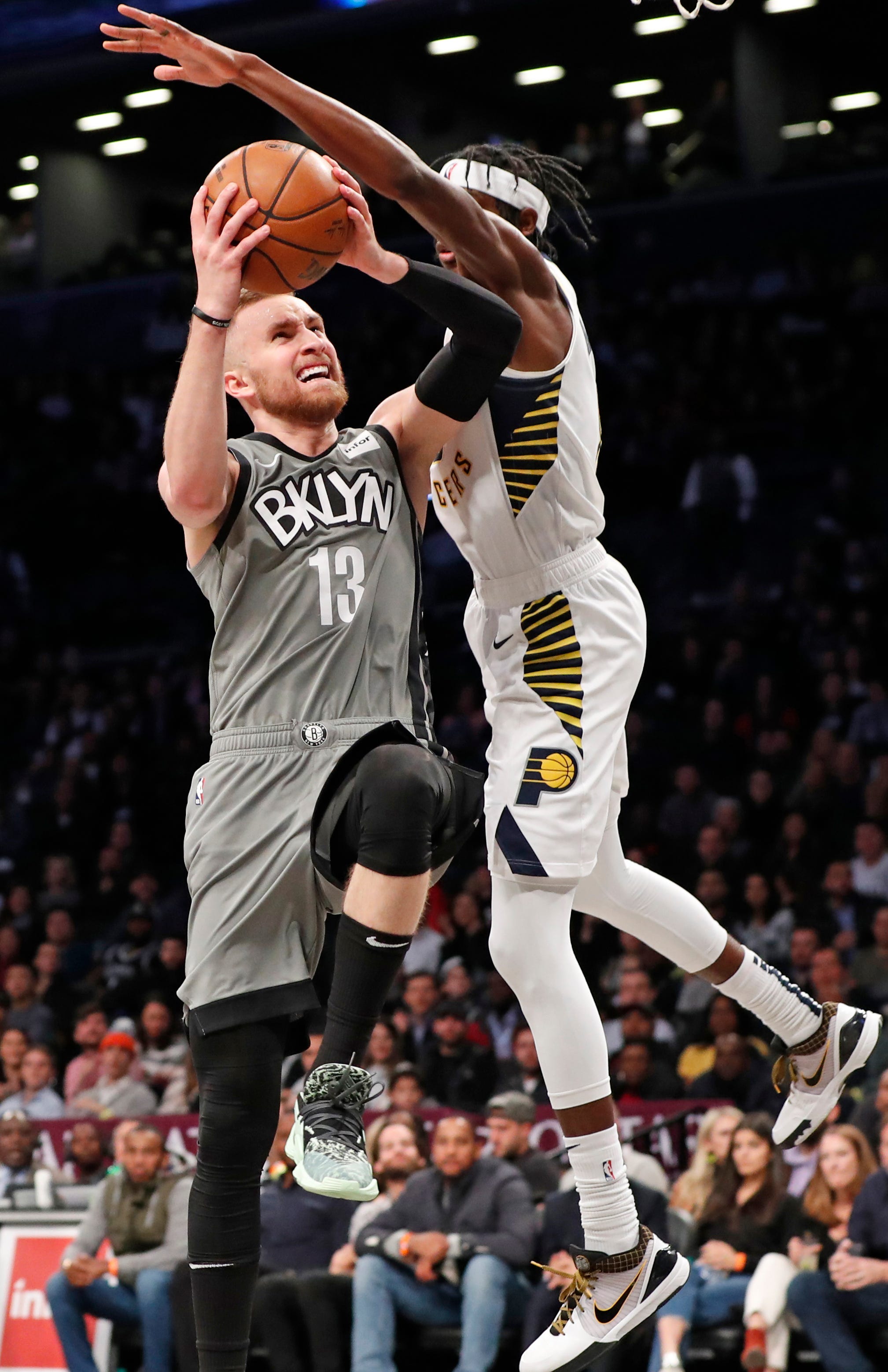 Indiana Pacers forward Justin Holiday, right, defends against Brooklyn Nets guard Dzanan Musa (13) during the second half of an NBA basketball game, Monday, Nov. 18, 2019, in New York.