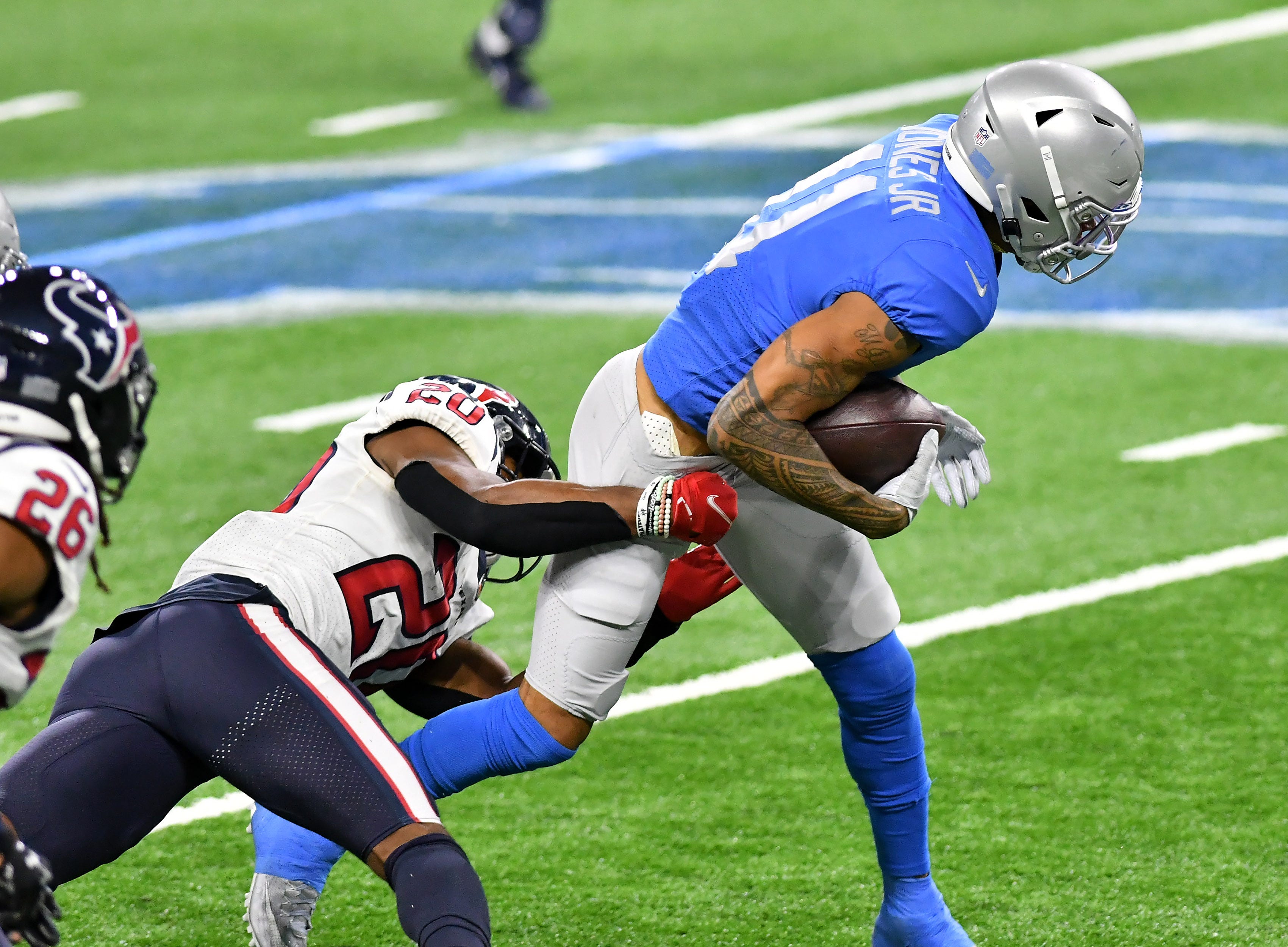 Texans strong safety Justin Reid (20) wraps up Lions wide receiver Marvin Jones Jr. (11) in the fourth quarter.