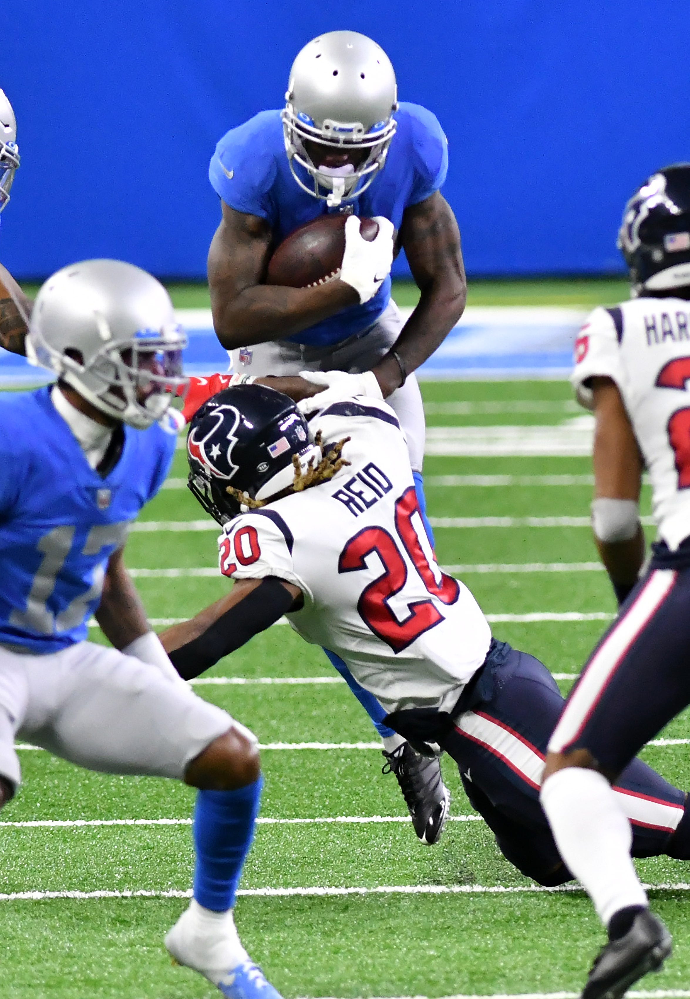 Texans strong safety Justin Reid (20) upends Lions wide receiver Mohamed Sanu Sr. (12) in the fourth quarter.