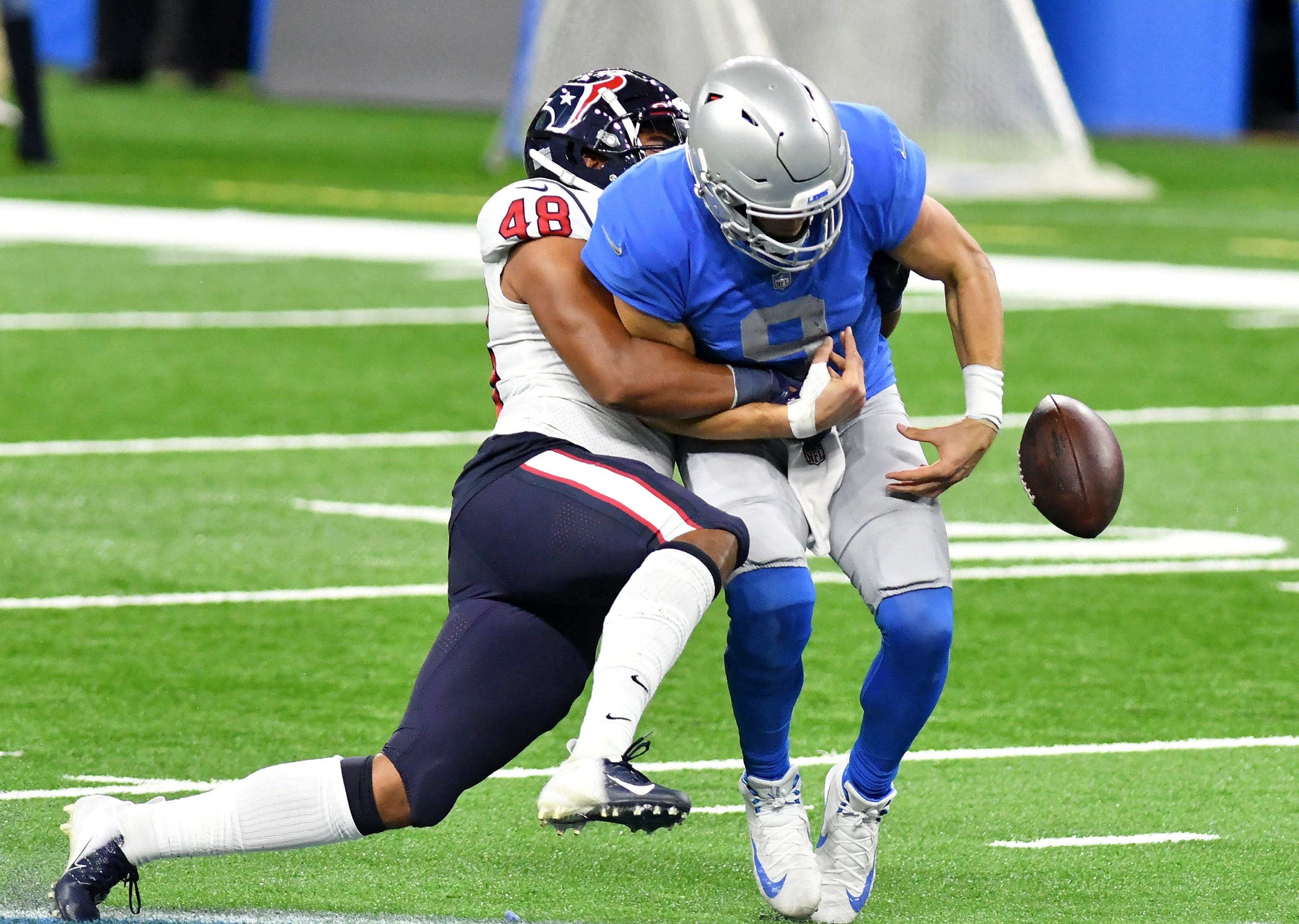 Texans linebacker Nate Hall (48) knocks the ball away from Lions quarterback Matthew Stafford (9) in the fourth quarter.  Detroit Lions vs Houston Texans on Thanksgiving Day at Ford Field in Detroit on Nov. 26, 2020.  Texans win 41-25.
