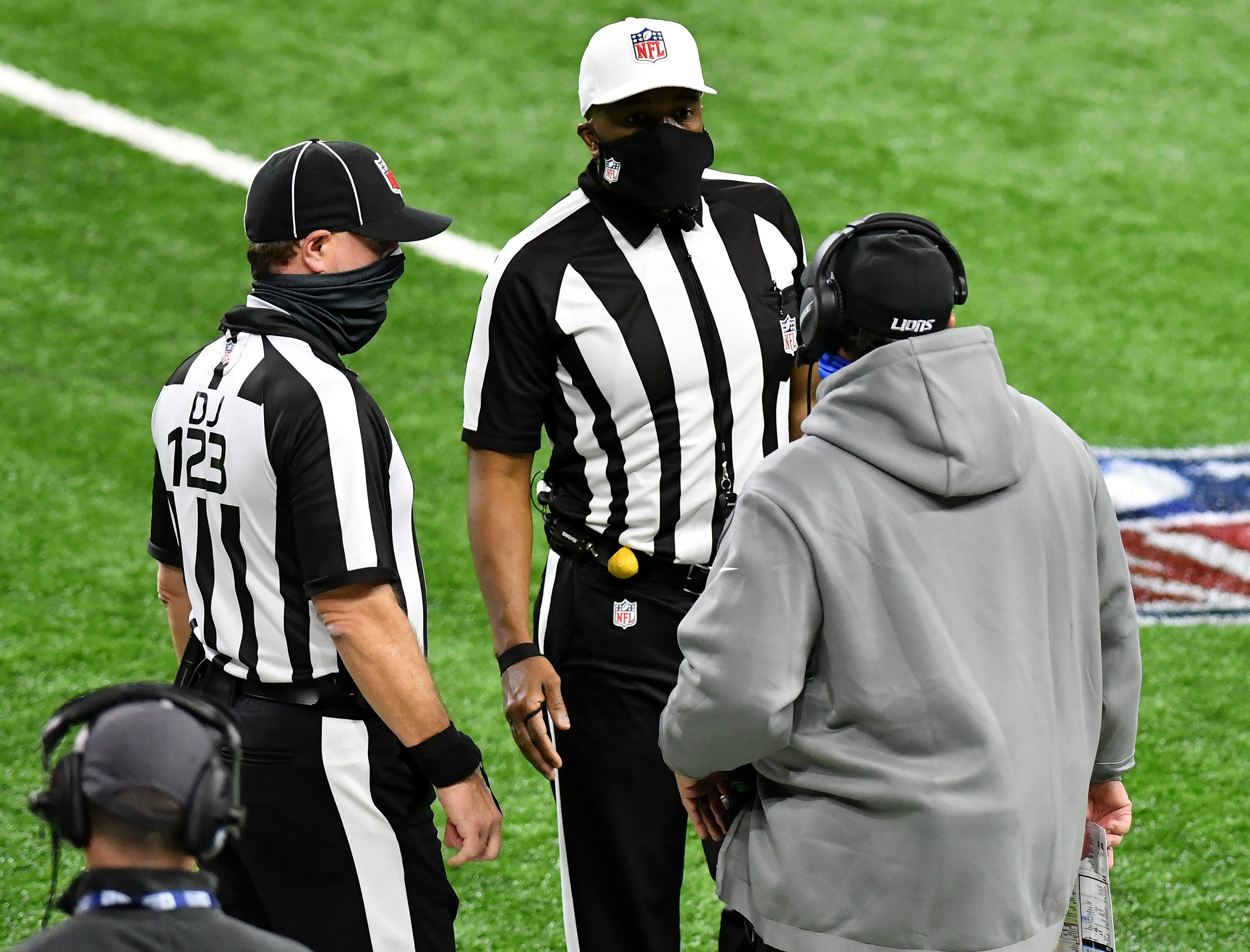 Officials talk with Lions head coach Matt Patricia after Patricia challenges a ruling on an attempted catch by Matthew Stafford in the third quarter.
