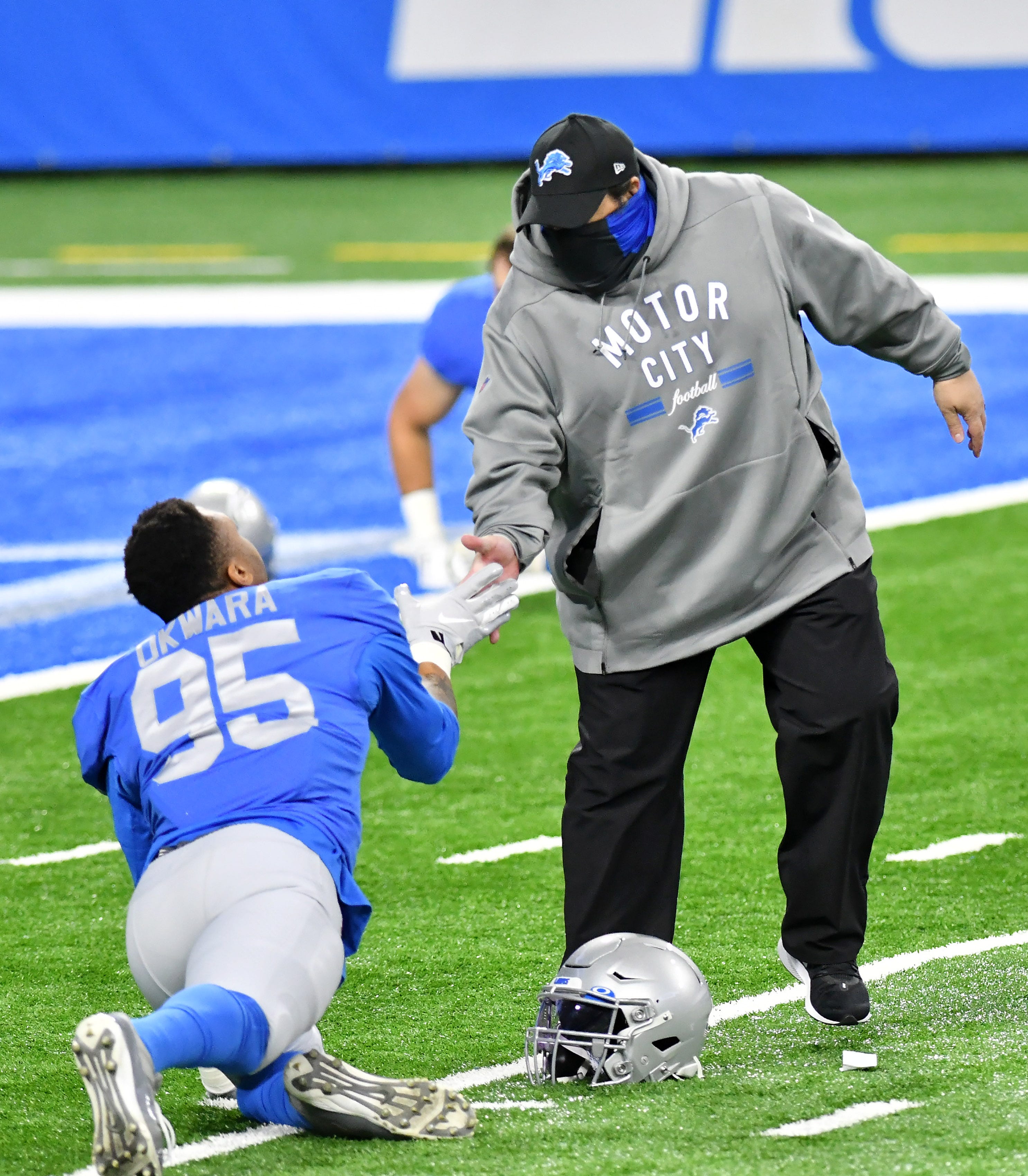 Lions head coach Matt Patricia greets Lions defensive end Romeo Okwara (95) before the game.  Detroit Lions vs Houston Texans on Thanksgiving Day at Ford Field in Detroit on Nov. 26, 2020.