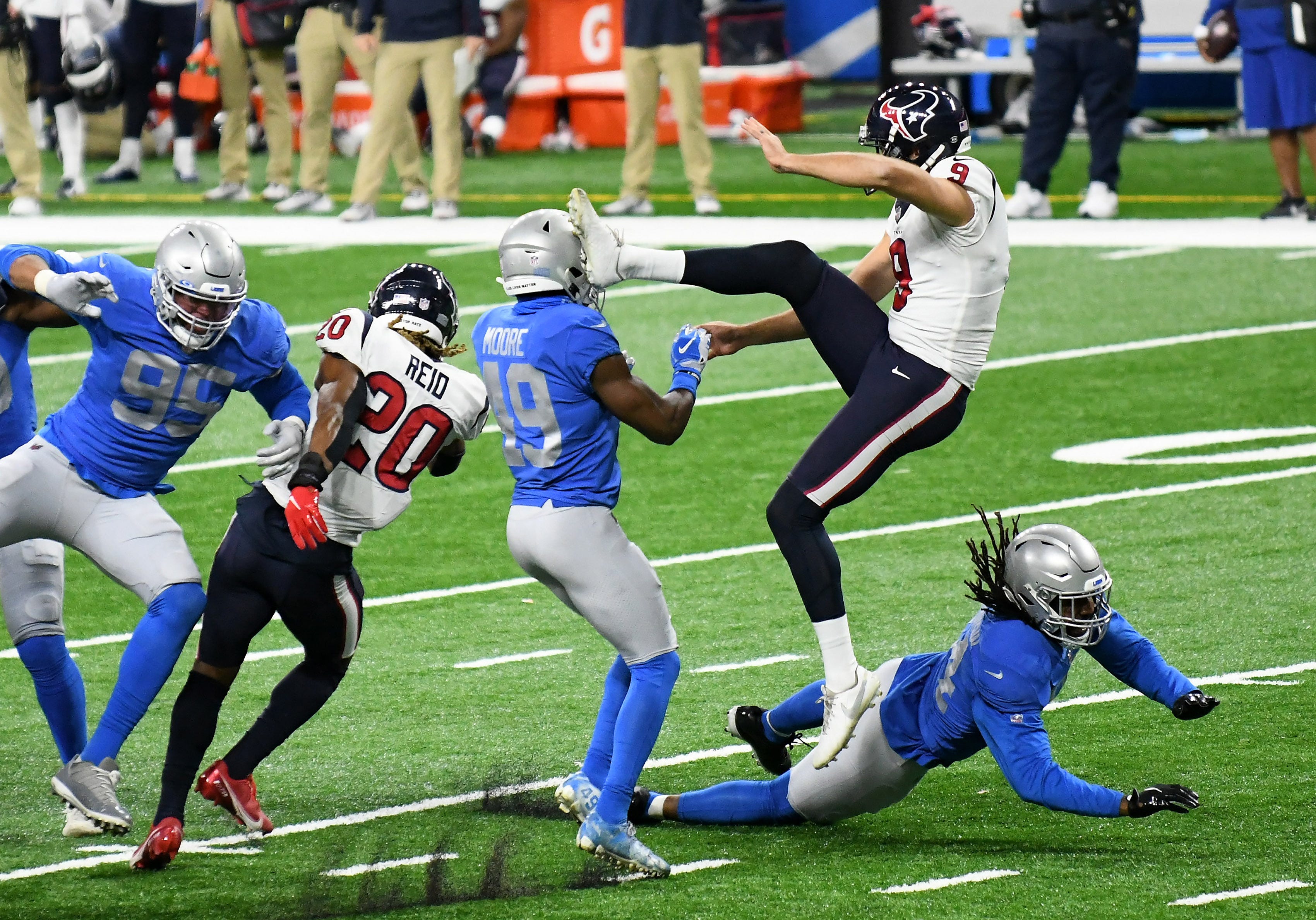 Lions safety C.J. Moore (49) and linebacker Jalen Reeves-Maybin (44) are called for a penalty for bumping into Texans punter Bryan Anger (9) in the fourth quarter.