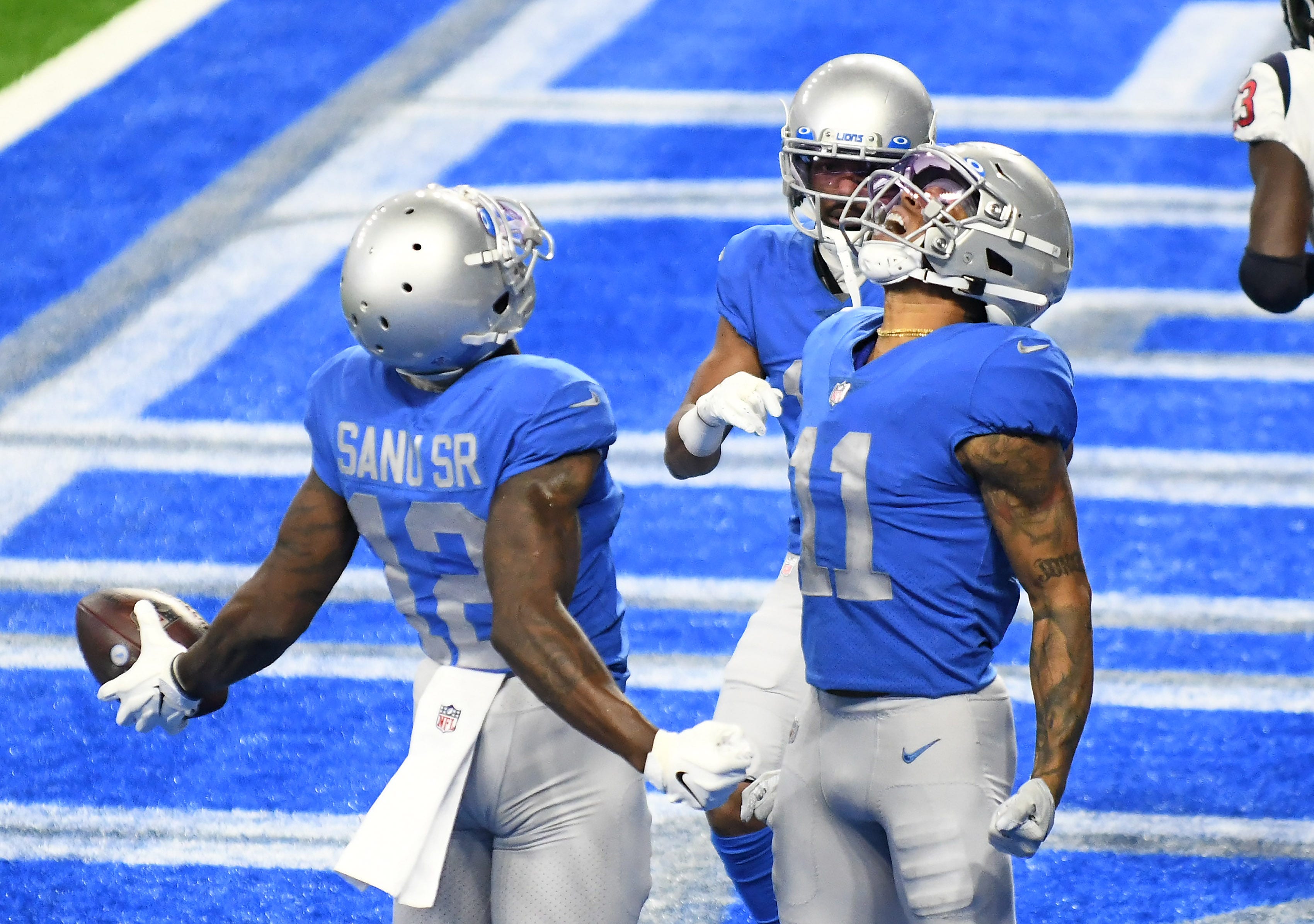 Lions wide receivers Mohamed Sanu Sr. (12) and Marvin Jones Jr. (11) react after Sanu's touchdown in the fourth quarter.