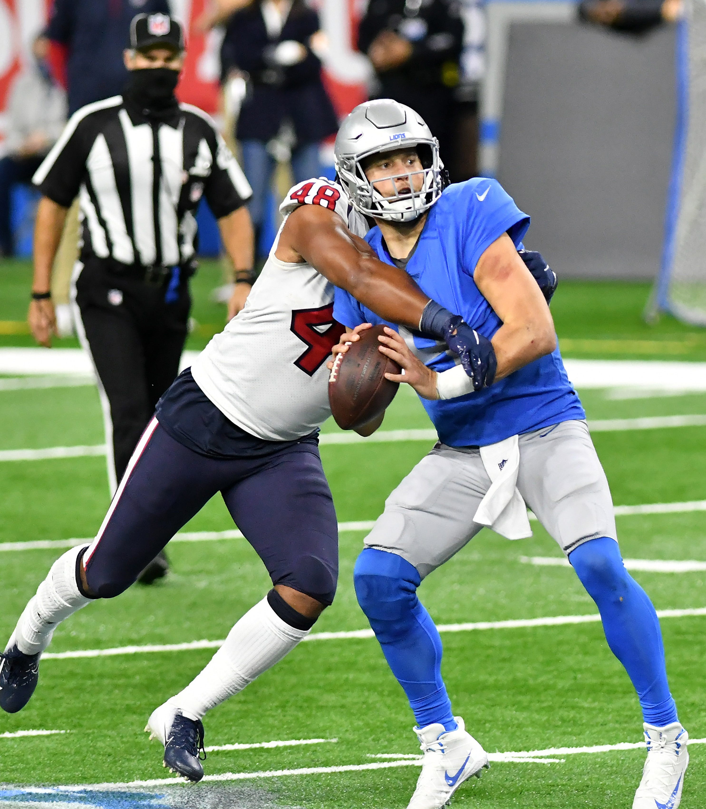 Texans linebacker Nate Hall (48) knocks the ball away from Lions quarterback Matthew Stafford (9) in the fourth quarter.