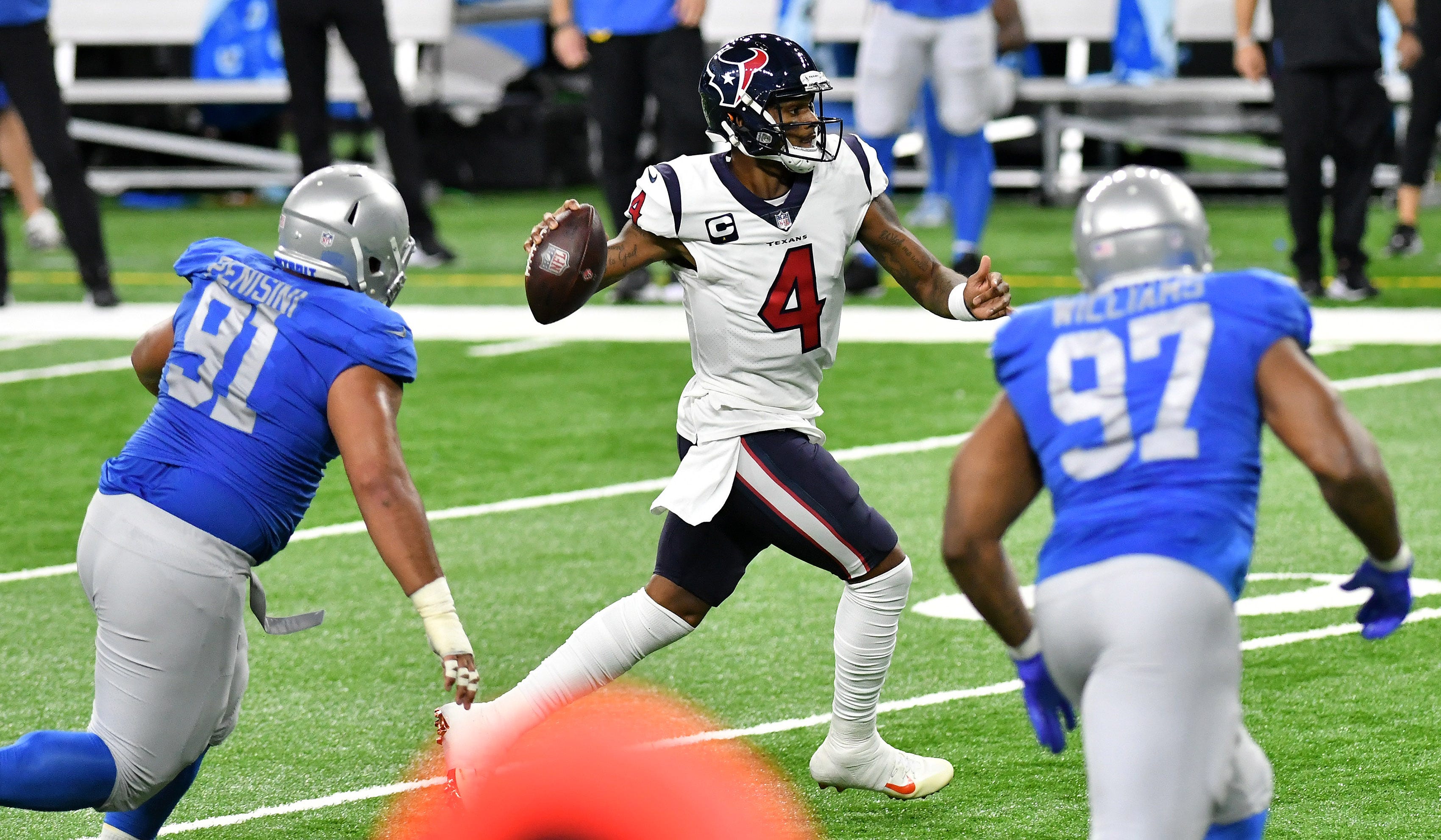 Lions defensive tackle John Penisini (91) and defensive end Nick Williams (97) chase Texans quarterback Deshaun Watson in the first half.