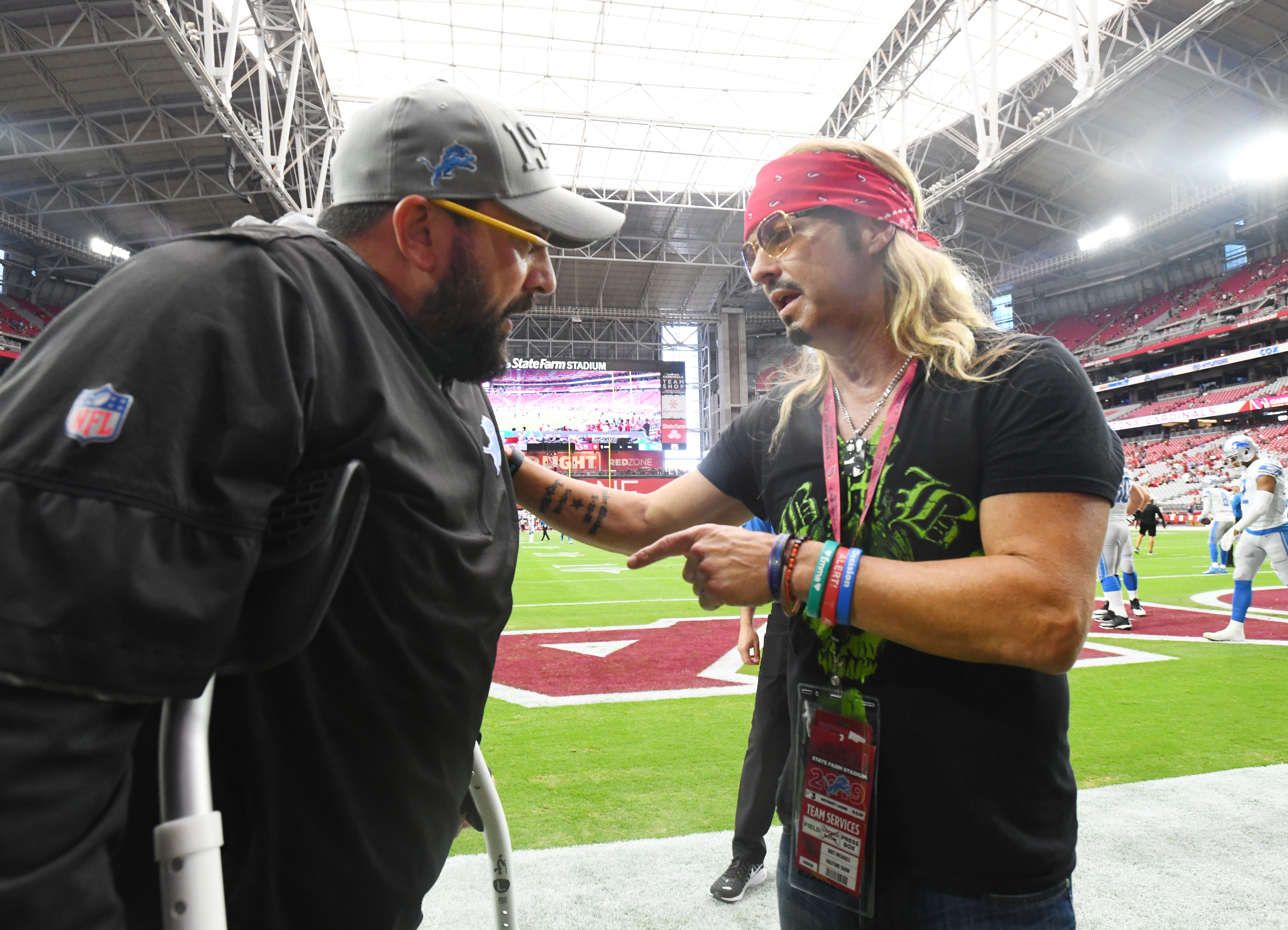 Singer Bret Michaels with the group Poison visits the sidelines in Phoenix, signing autographs and visiting with Detroit Lions head coach Matt Patricia before the game on September 8, 2019.