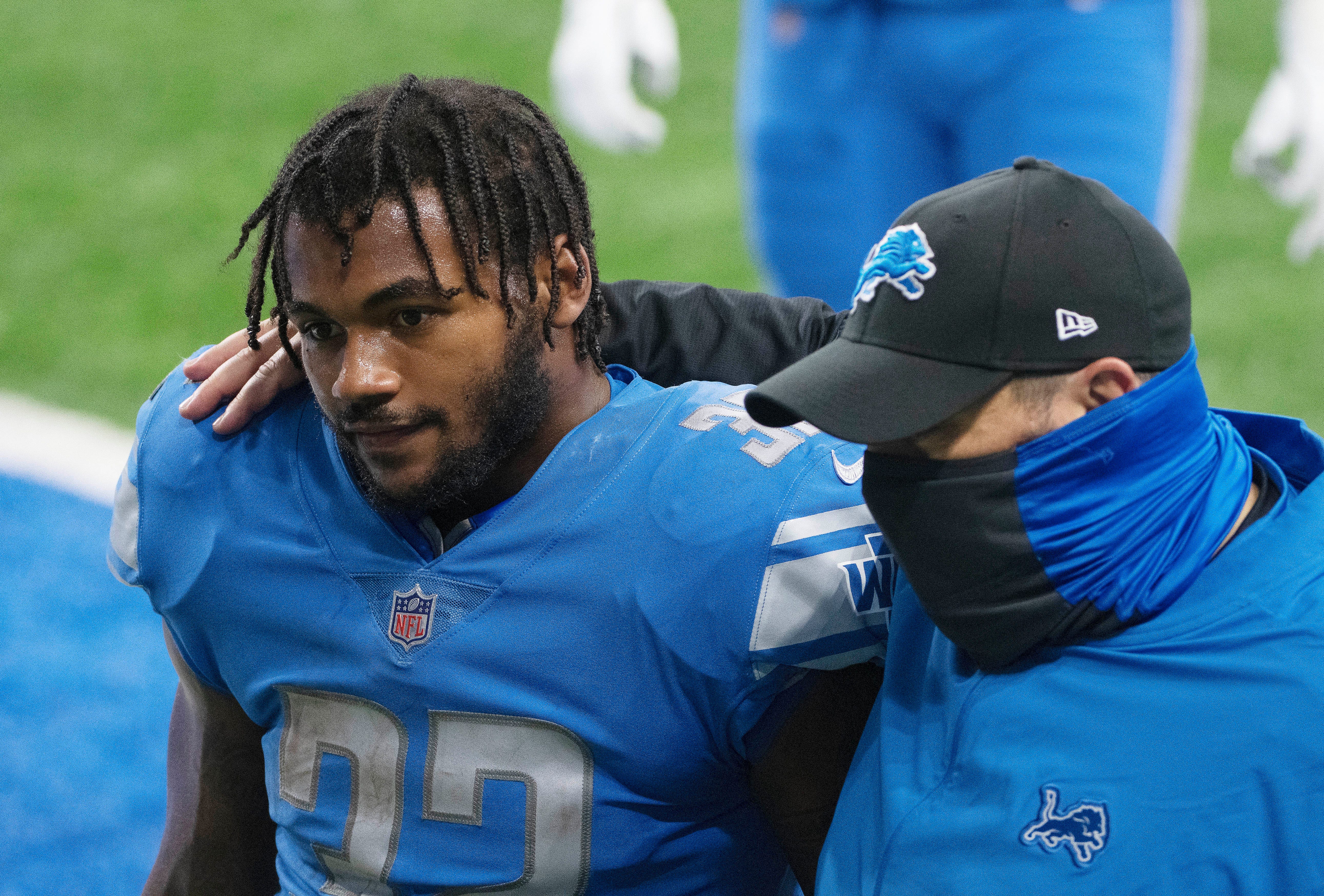 Lions rookie running back D'Andre Swift is comforted by head coach Matt Patricia walking off the field after dropping a possible game-winning touchdown catch late in the fourth quarter on September 13, 2020.