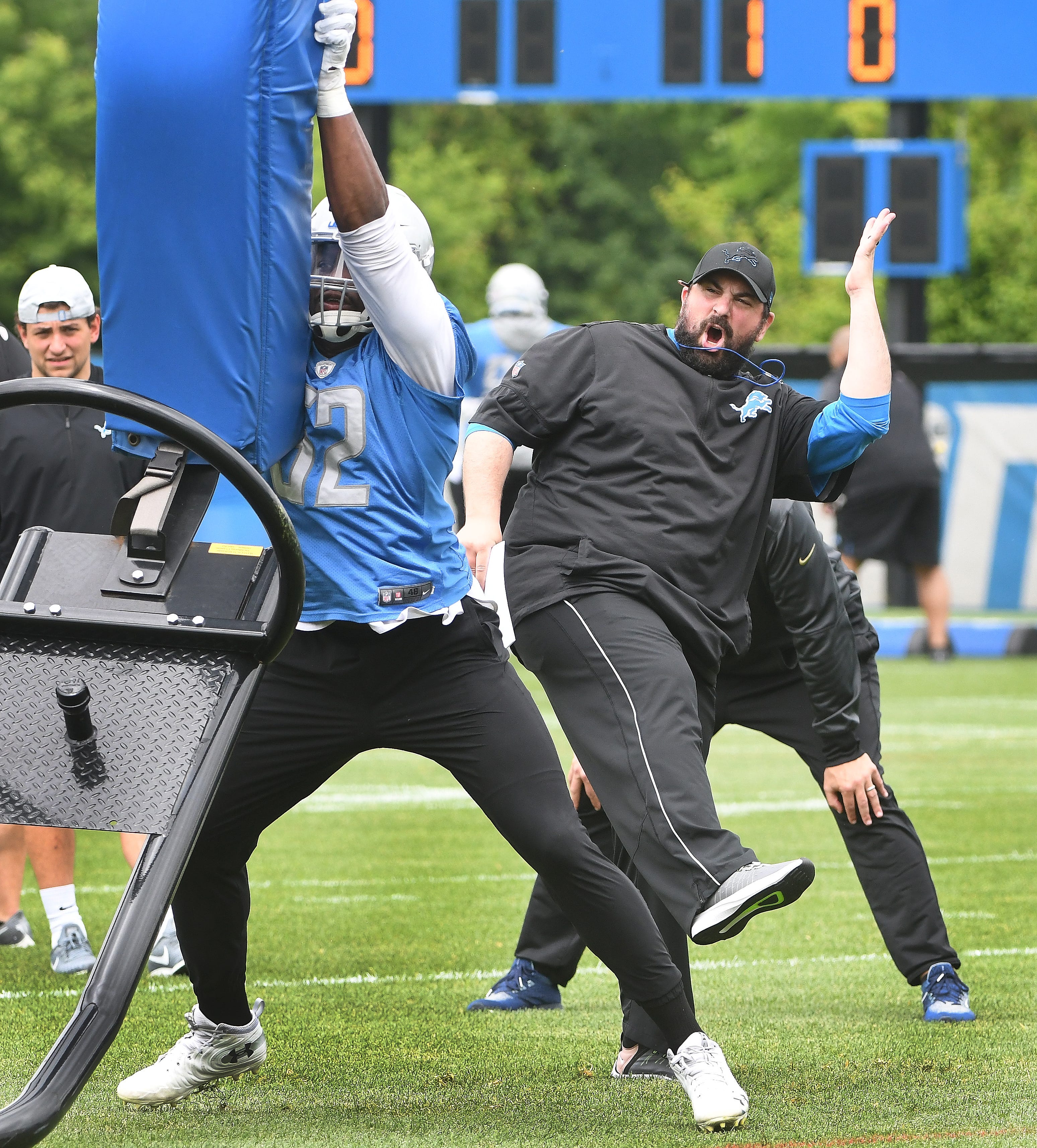 Lions head coach Matt Patricia works with linebacker Christina Jones hitting the sled during drills during minicamp in Allen Park, Michigan on June 5, 2019.