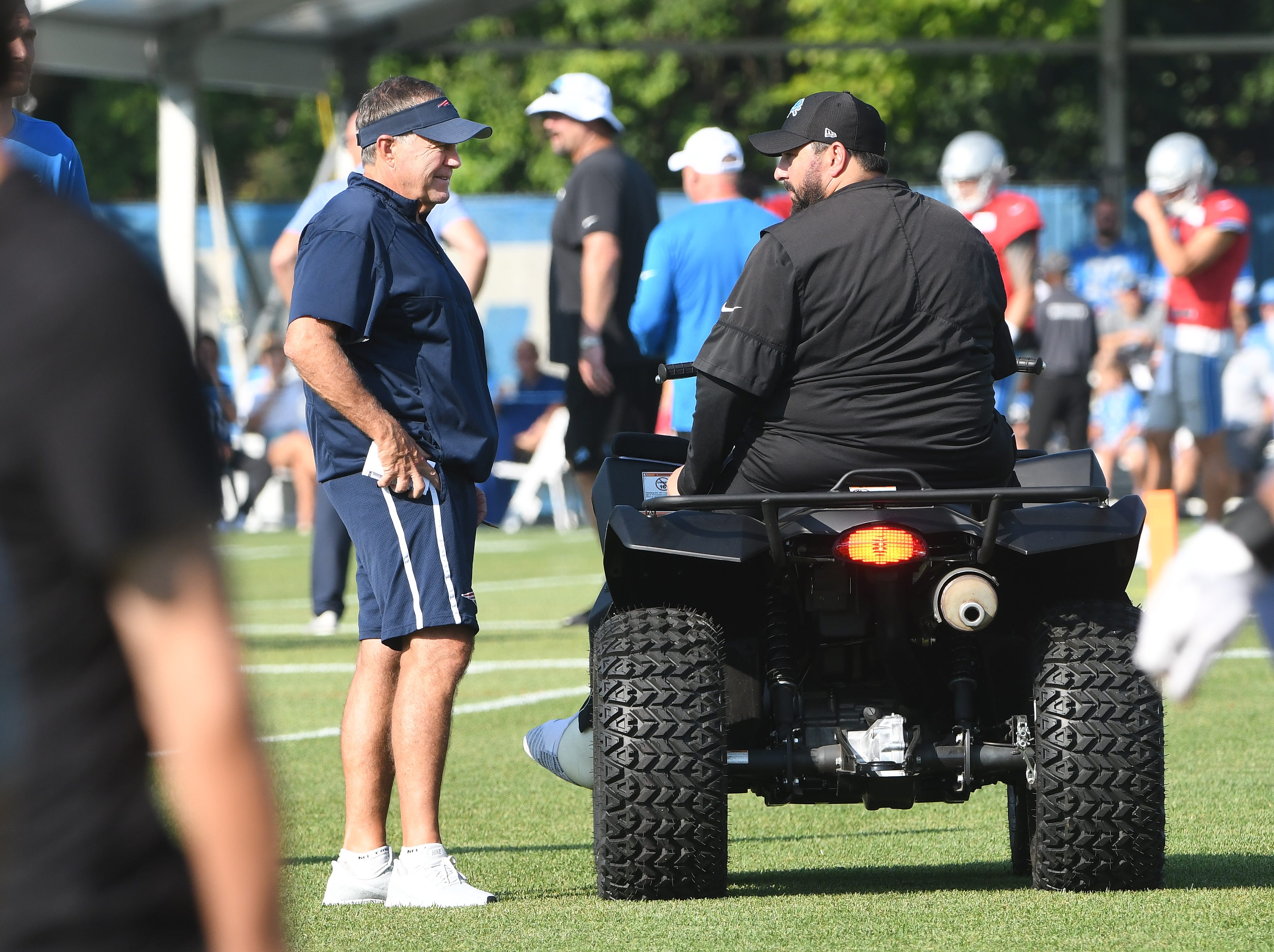 Patriots head coach Bill Belichick talks with one of his former coaches, Lions head coach Matt Patricia as the players make their way onto the field. Lions, New England Patriots combined practice at the training facility in Allen Park, Michigan on August 5, 2019.
