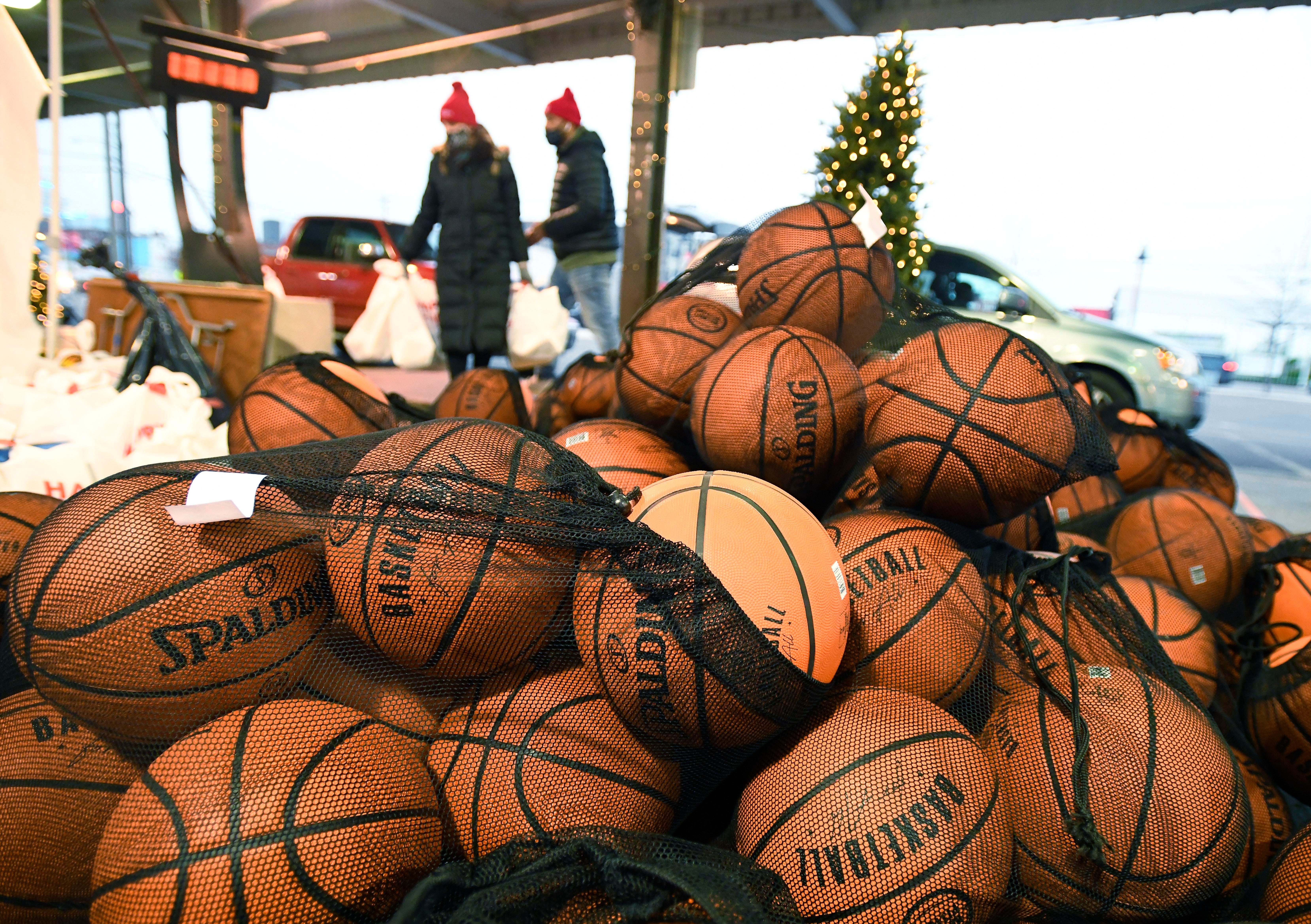Piston basketballs piled up, soon to be dibbled, shot and dunked by lucky recipients at a drive-through toy pickup in Eastern Market.