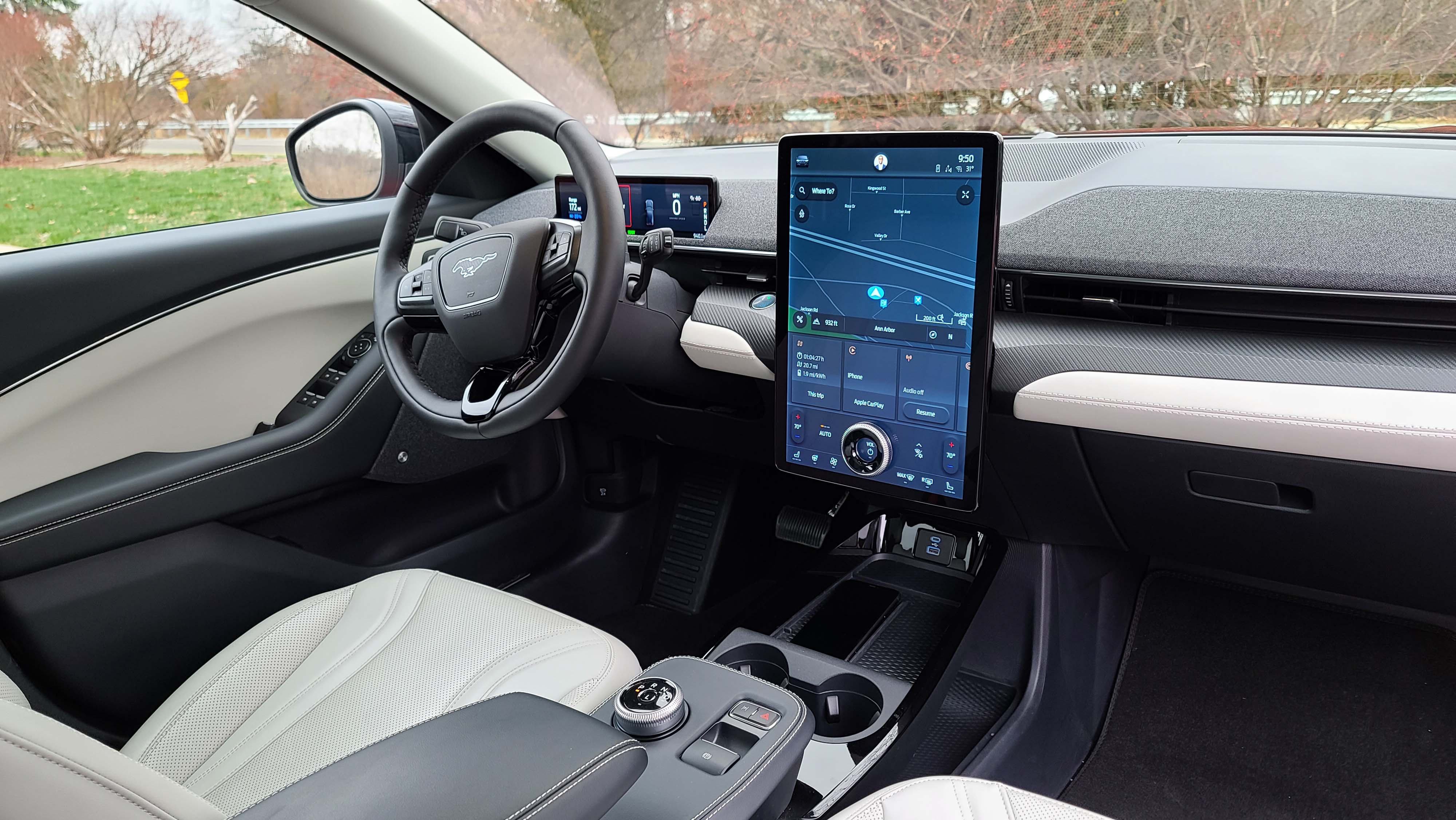 The 2021 Ford Mustang Mach-E interior is dominated by a 15.5-inch screen that offers navigation as well as "pages" for different features like trip info, music, and Apple CarPlay connectivity. Familiar Ford features include a rotary shifter.