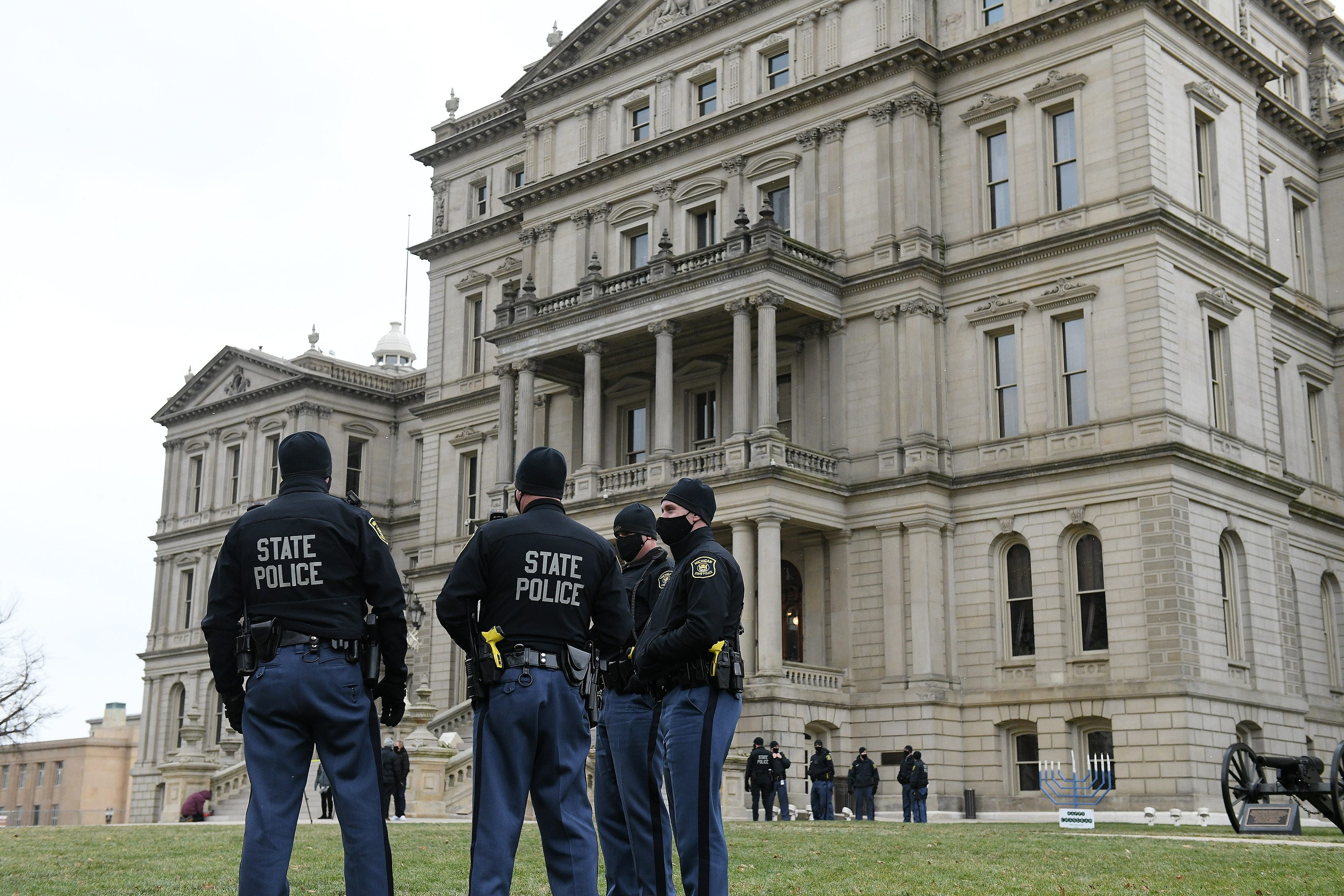 Michigan State Police officers on duty around a largely empty area surrounding the Michigan State Capitol in Lansing, Mich. on Dec. 14, 2020.   The electors are casting their votes today at the capitol for the president and vice president.