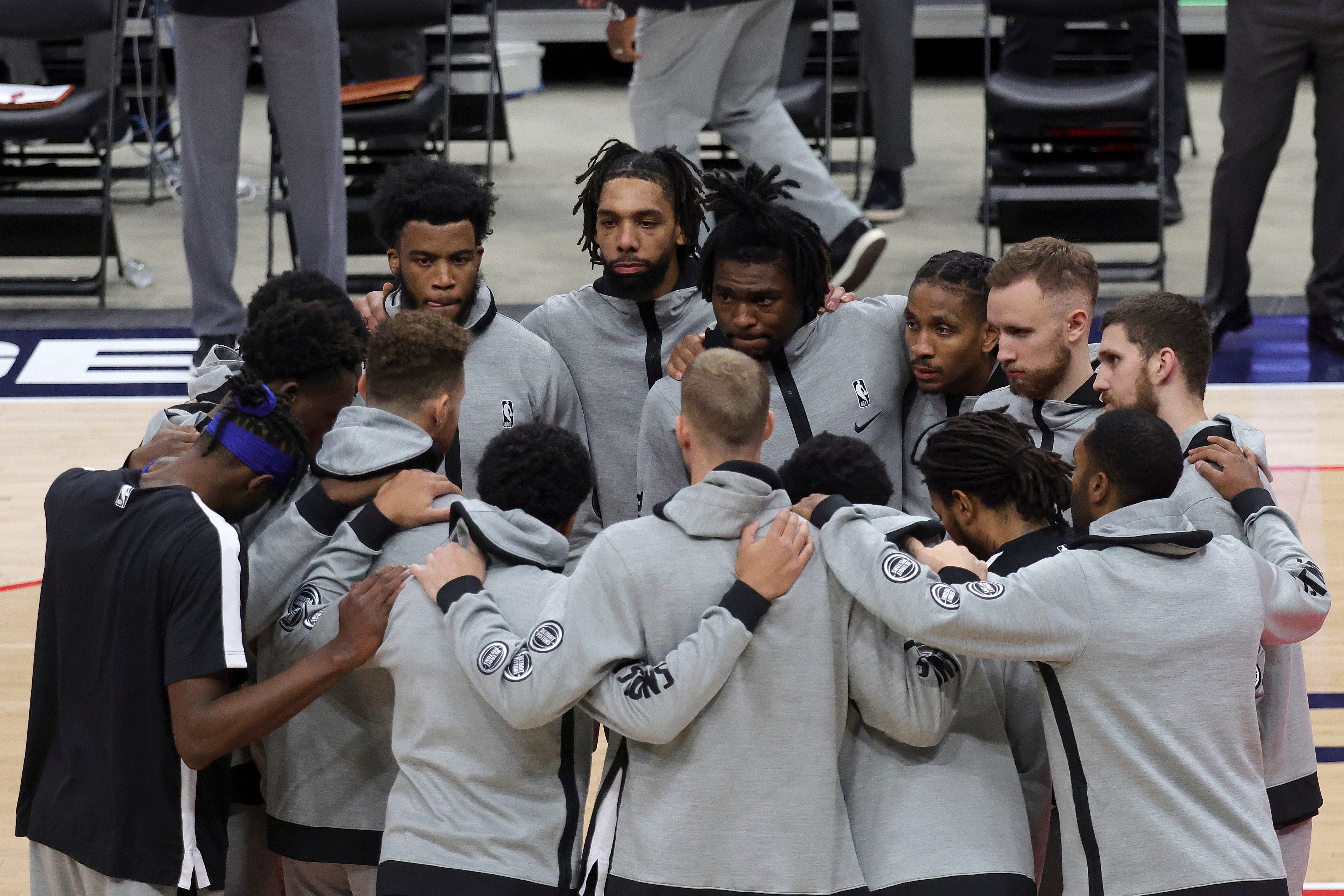 Members of the Detroit Pistons gather before the start a preseason NBA basketball game against the Washington Wizards, Saturday, Dec. 19, 2020 in Washington.