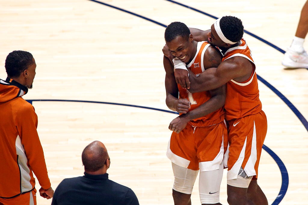 Texas guards Andrew Jones (1) and Courtney Ramey (3) celebrate after Jones scored against West Virginia during the second half.