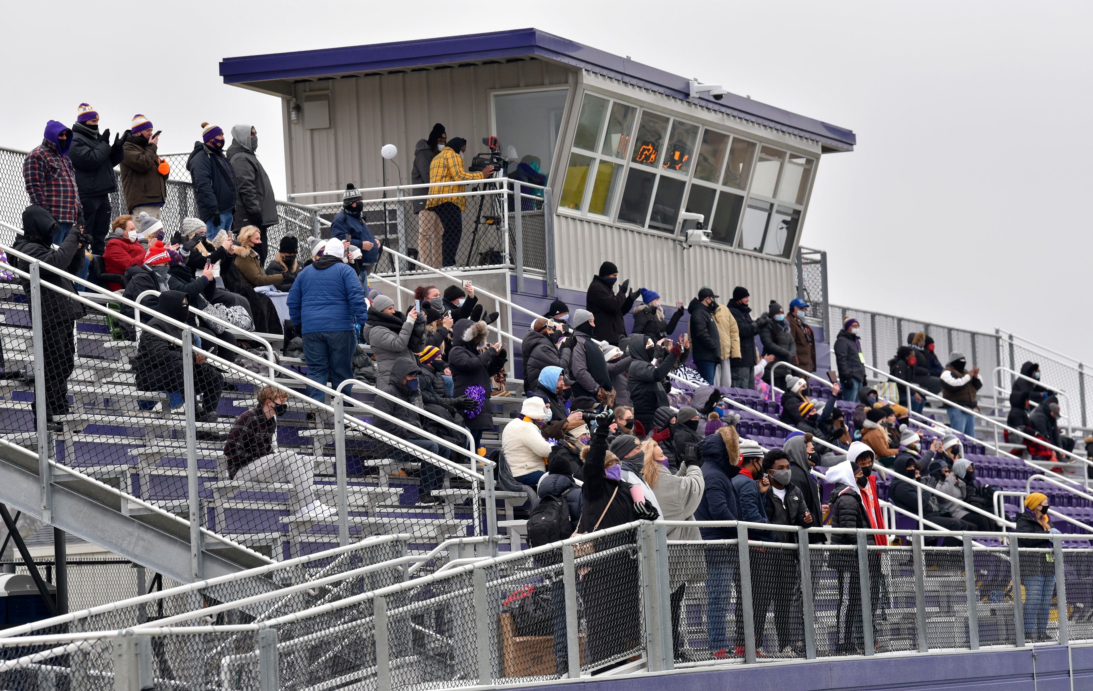 Fans sit in front of the new press box.