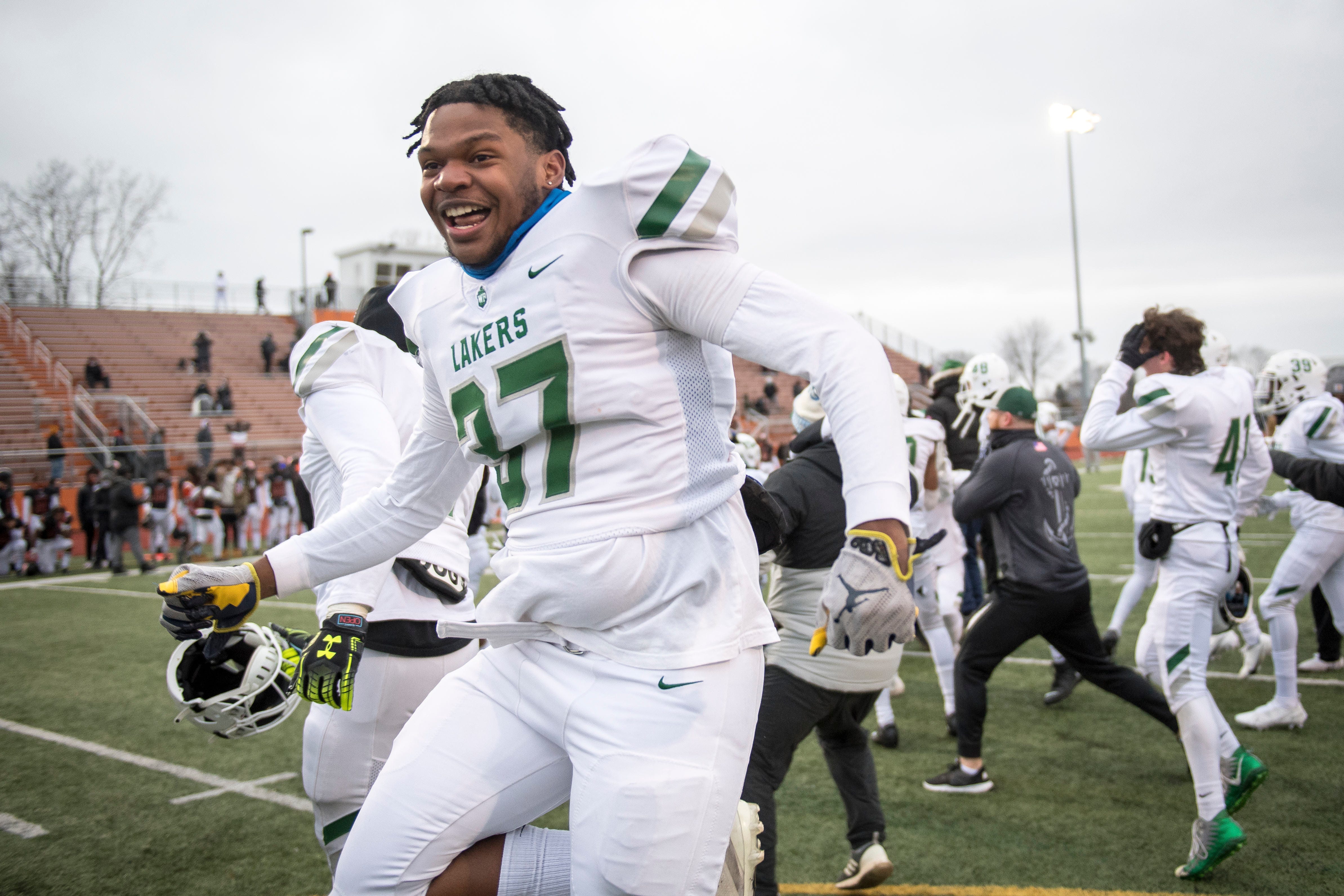 West Bloomfield junior Jaydan Montgomery (37) celebrates after the Lakers defeated Belleville 35-34 in double overtime of a state football semi-final game at Belleville on Saturday,  Jan. 16, 2021.