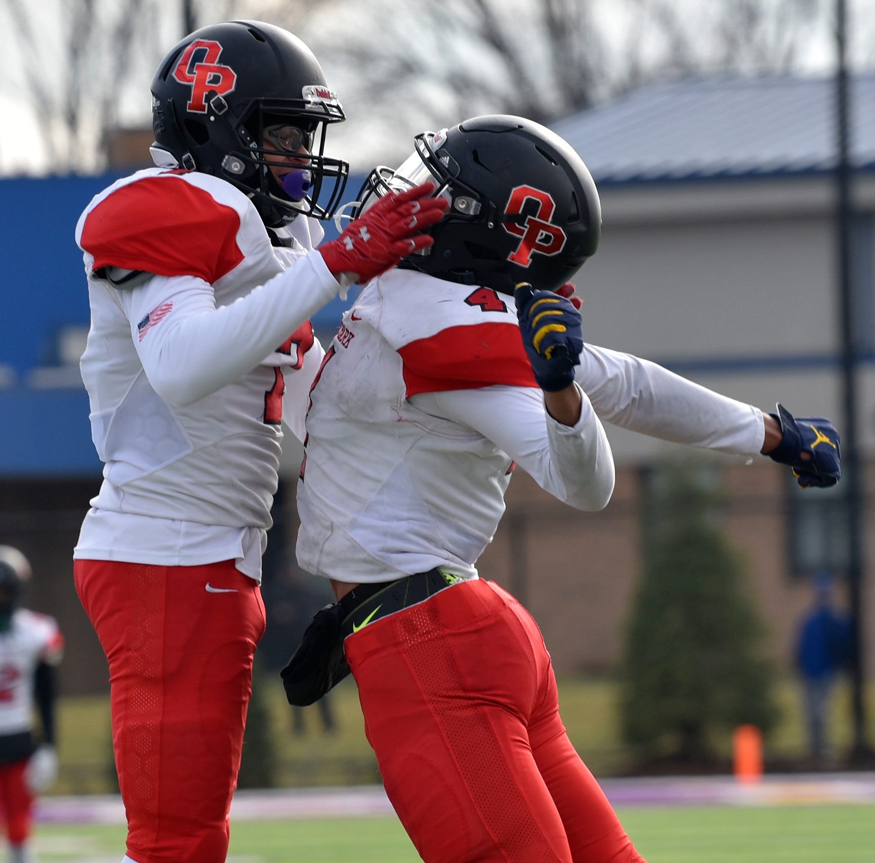Oak Park's Amari Harris (4) celebrates his two-point conversion reception with Bwana Miller (7) midway through the fourth quarter.