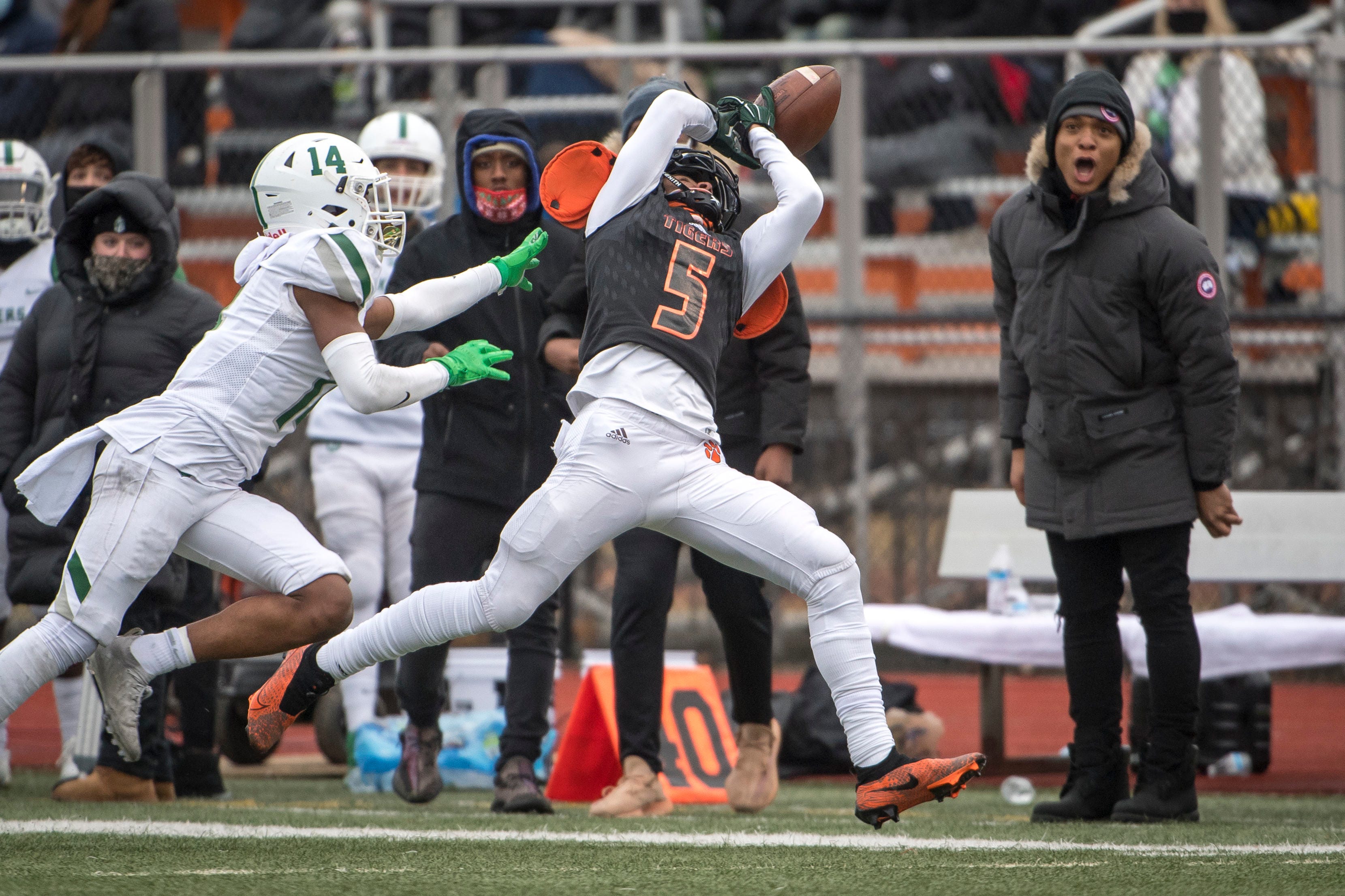 Belleville junior wide receiver Tyree Lockett (5) can't pull in this pass while being covered by West Bloomfield senior Grant Lenton (14) during the third quarter.